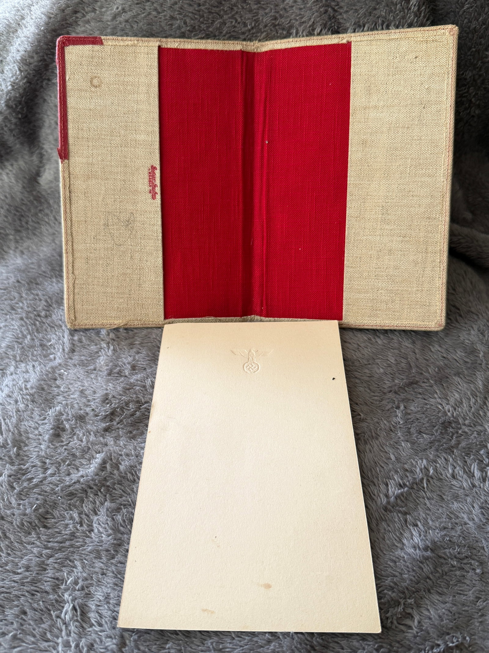 WWII German Reich Chancellery Embossed Stationery Folder with Eagle Letter Paper: This WWII German Reich Chancellery stationery folder contains an embossed sheet of official-style writing paper featuring the Third Reich national eagle above a swastika at the top center. The protect
