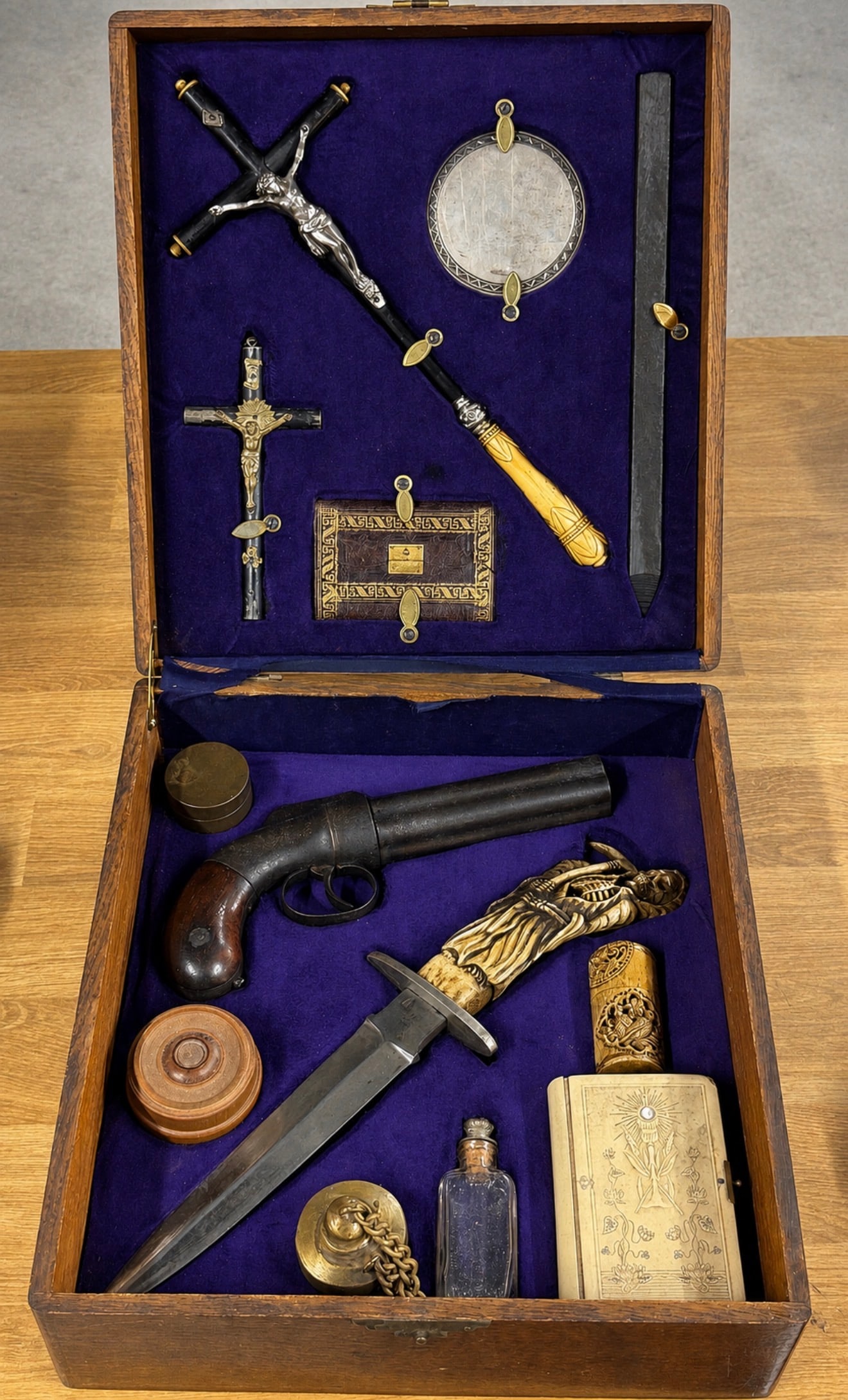 1800's European Vampire Slaying Travel Kit with Pepperbox Pistol, Fighting Knife & Religious: This elaborate 19th-century European Vampire Slaying Travel Kit is housed in a finely crafted oak case fitted with deep purple velvet and an assortment of specialized compartments containing an impres