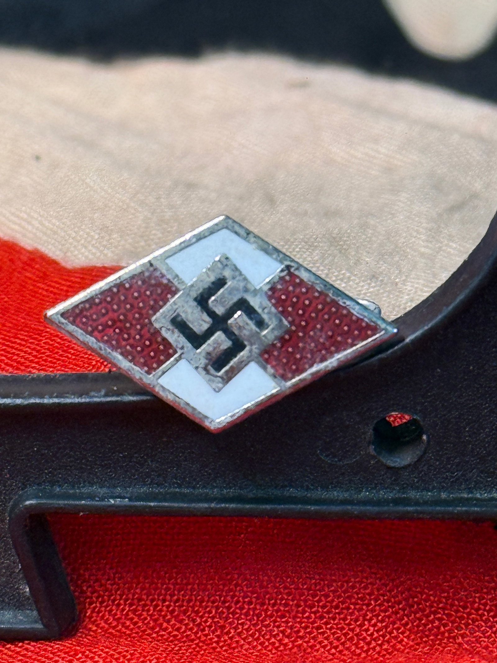 WWII Hitler Youth Membership Lapel Pin (RZM M1/6): This WWII Hitler Youth membership lapel pin features the familiar red, white, and black enamel diamond design with central swastika. The reverse retains its original pin assembly and is marked with th
