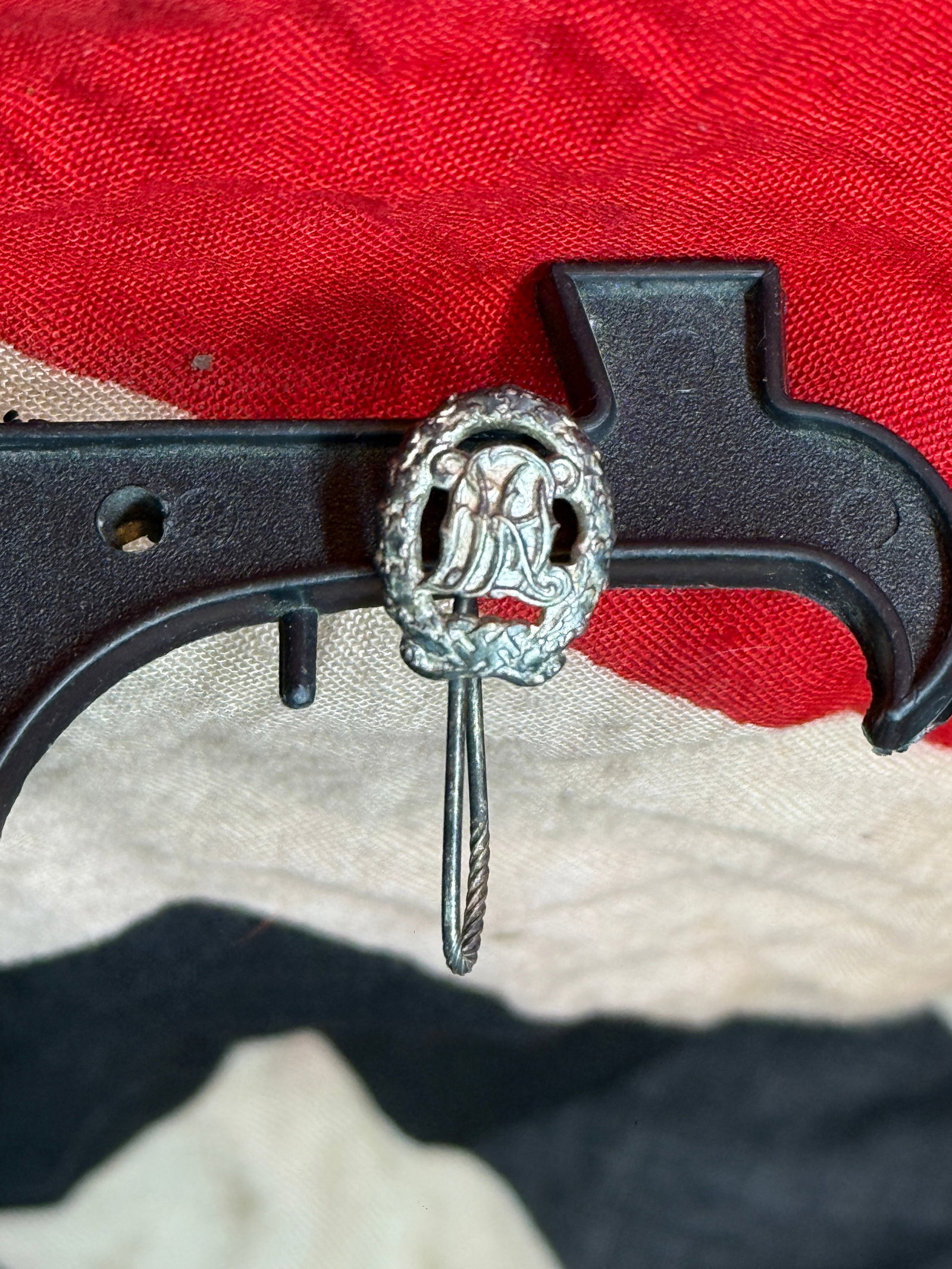 WWII German DRL Sports Badge Stickpin – Deutscher Reichsbund für Leibesübungen: This German DRL sports stickpin features an oval wreath surrounding the stylized intertwined “DRL” emblem associated with the Deutscher Reichsbund für Leibesübungen (German Reich Association