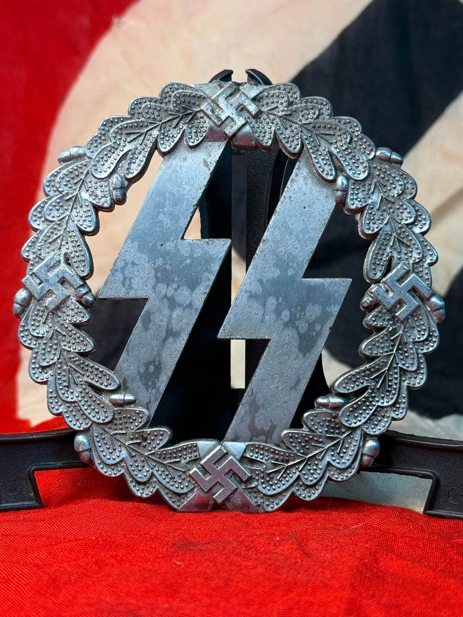 WWII German SS Runes & Wreath Desk Ornament (Third Reich): This WWII German SS desk ornament features the iconic SS runes positioned within a large oak leaf wreath incorporating four swastikas at the cardinal points. The decorative openwork construction and s