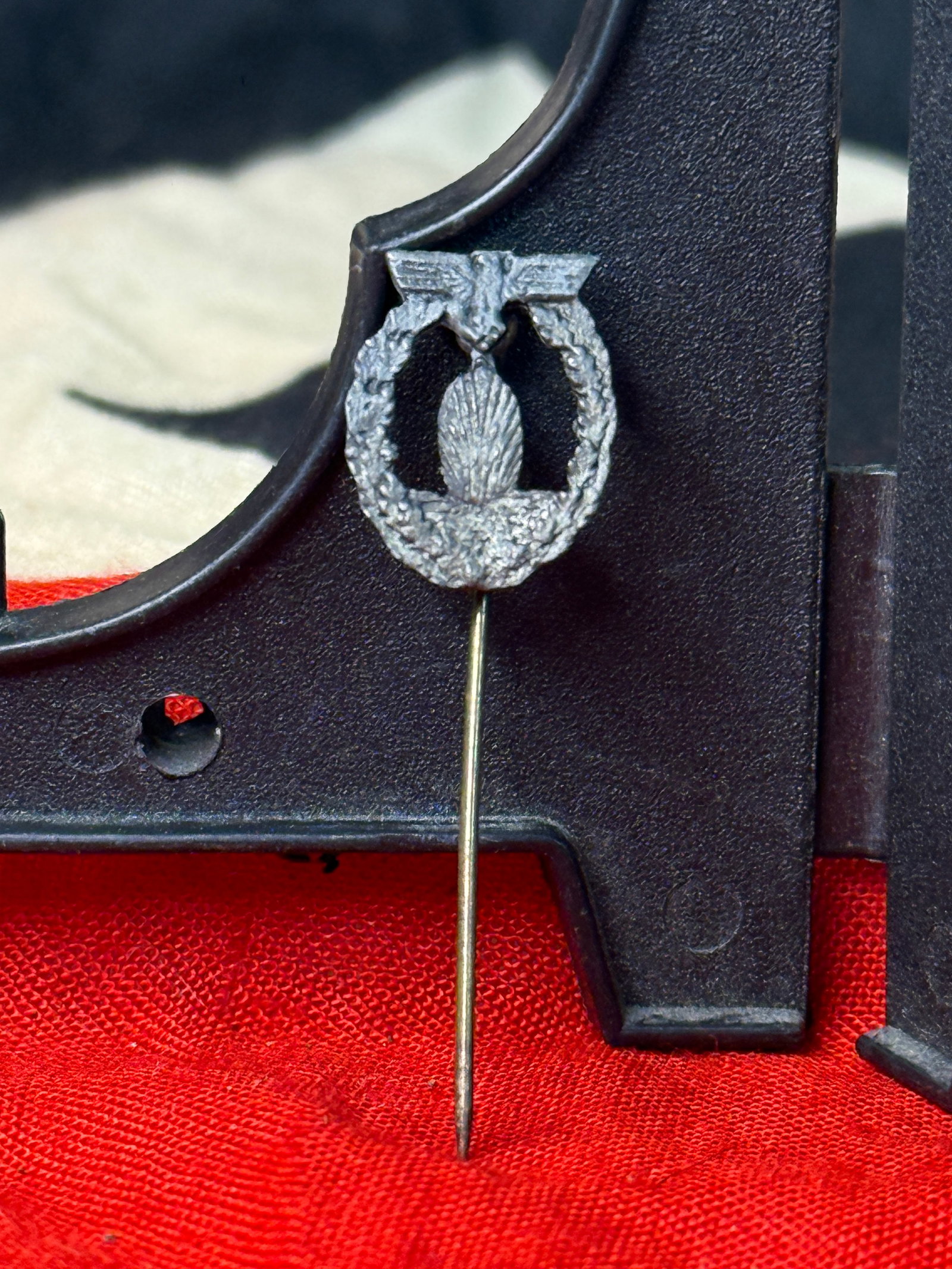 WWII German Kriegsmarine Minesweeper War Badge Stickpin: This WWII German Kriegsmarine Minesweeper War Badge stickpin is a miniature version of the naval award featuring an exploding sea mine surrounded by an oak leaf wreath and surmounted by the German nat