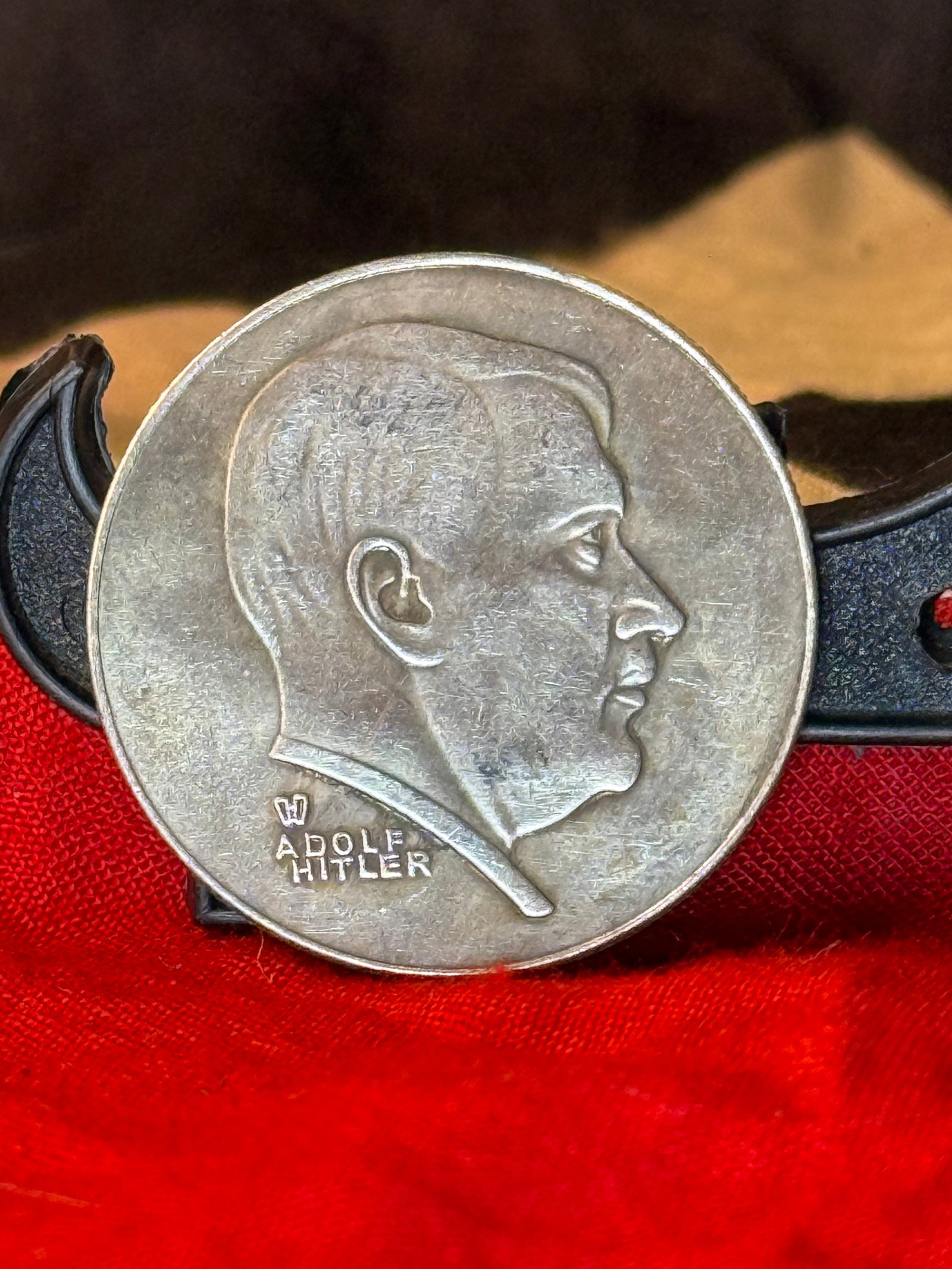 WWII German Third Reich Adolf Hitler Portrait Commemorative Medal: This German Third Reich commemorative medal features a right-facing portrait of Adolf Hitler on the obverse with his name below, while the reverse depicts a Wehrmacht steel helmet above a spread-wing 