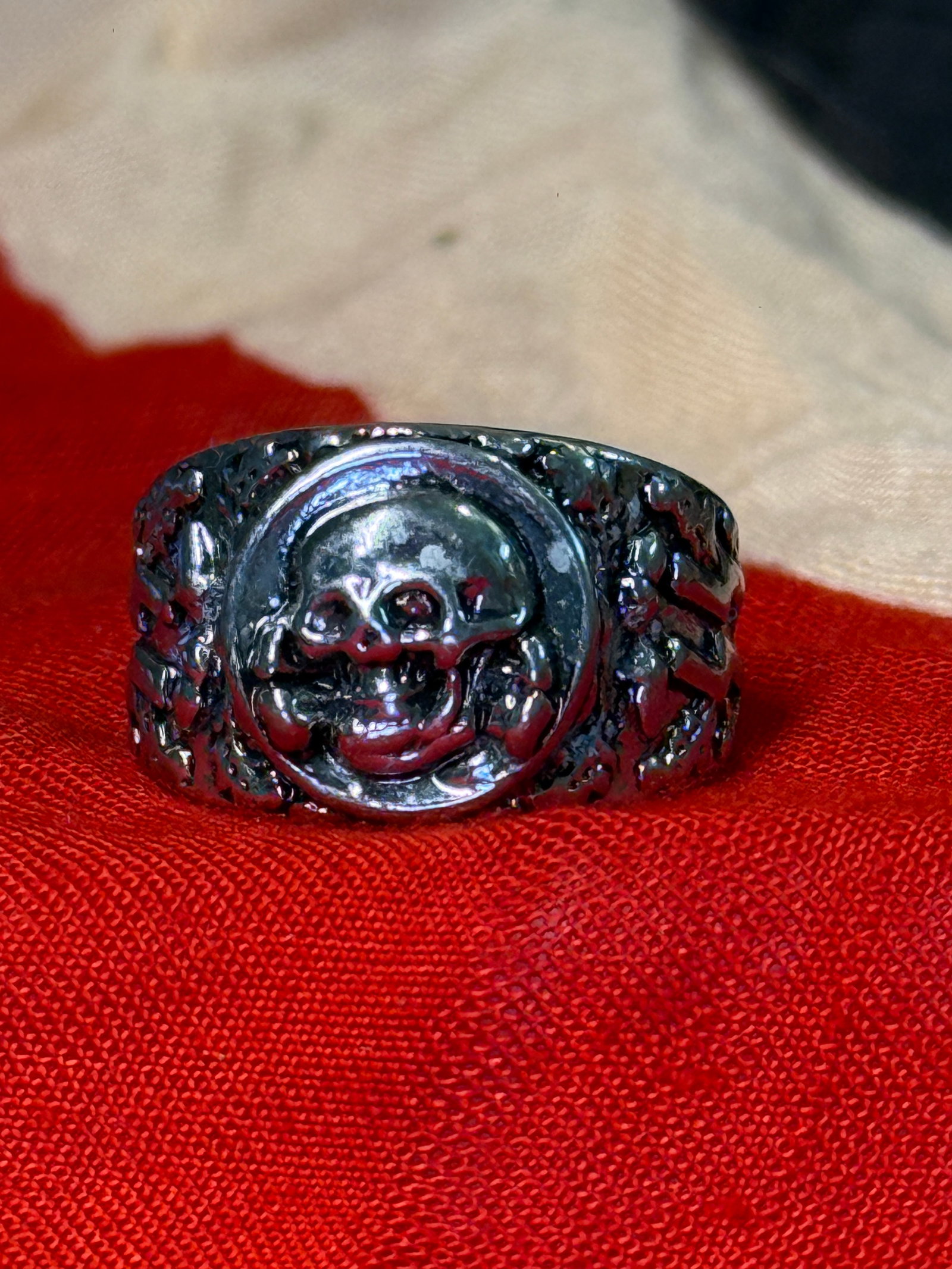 WWII German Waffen-SS Totenkopf Personal Silver Ring: This WWII German personal ring features the iconic Totenkopf (Death's Head) skull prominently displayed within a raised circular bezel, with decorative oak leaves, bones, and stylized SS runes extendi