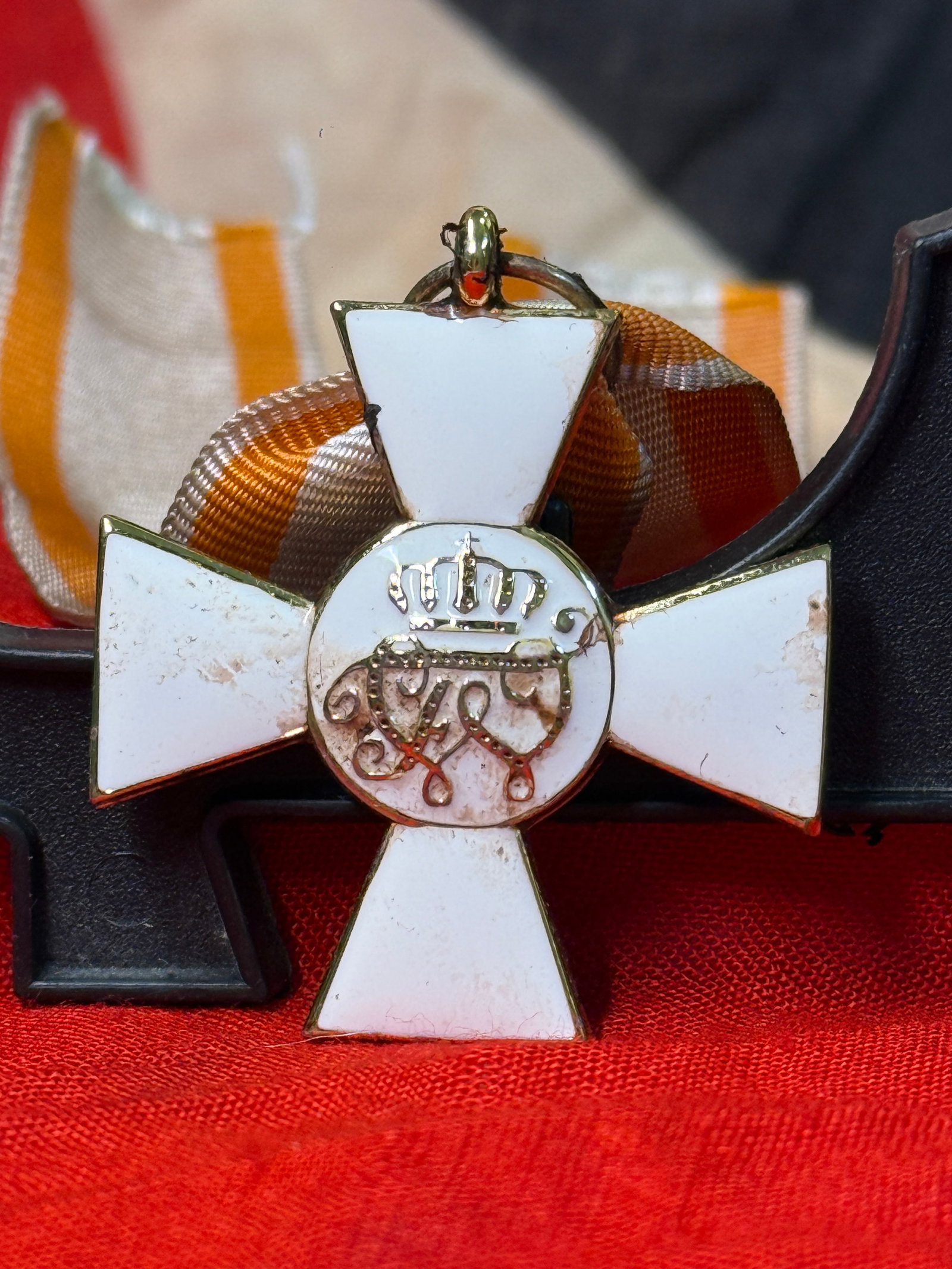 Imperial Russian Order of St. George Medal: This white enameled cross medal displays the crowned monogram of Tsar George on the obverse with a red double-headed Imperial eagle on the reverse and is suspended from its traditional orange and blac