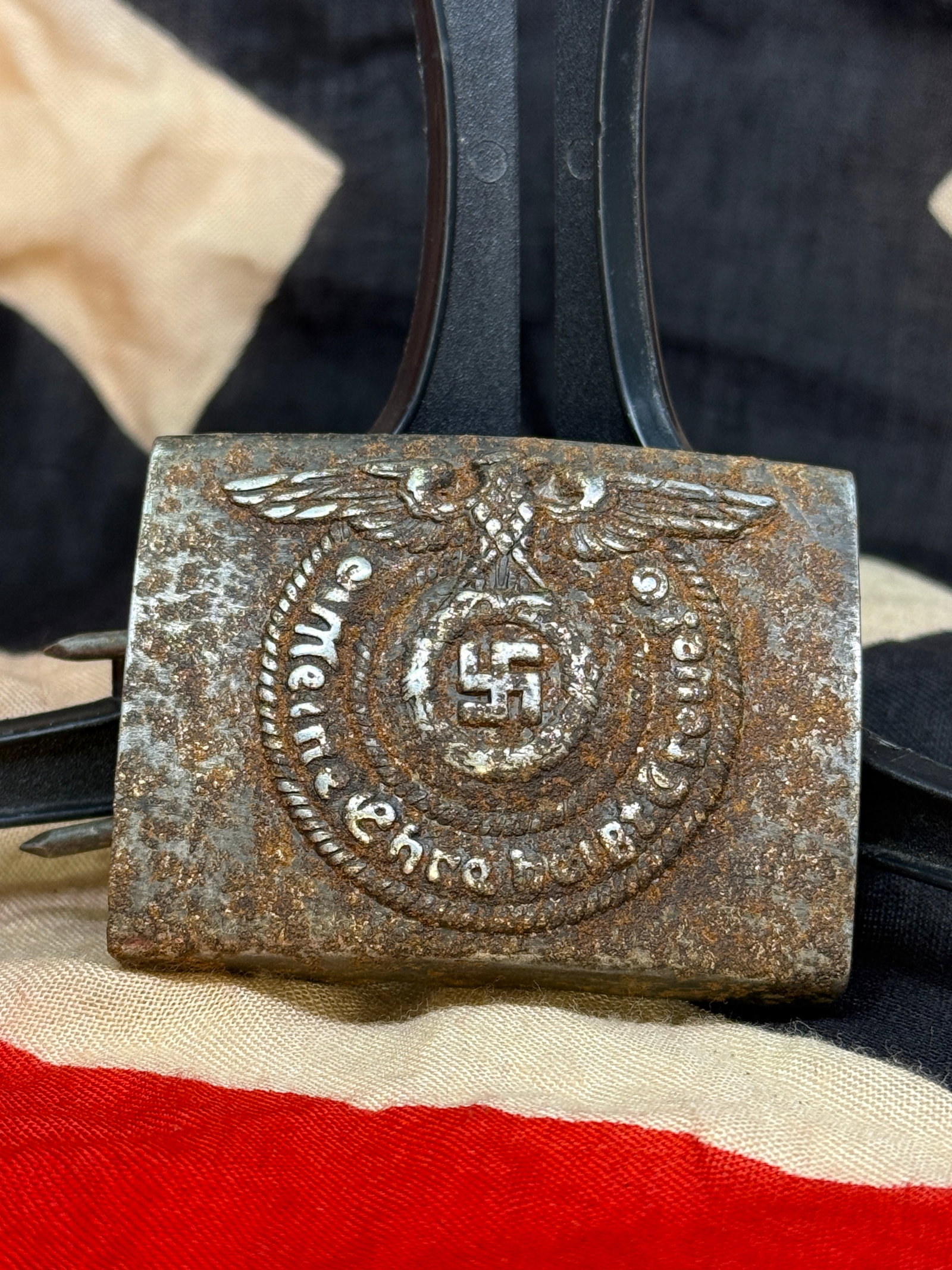WWII German SS “Meine Ehre Heißt Treue?? Enlisted Belt Buckle – Eagle & Swastika: This WWII German SS enlisted-style belt buckle features the characteristic raised eagle and swastika design surrounded by a rope-pattern border and the German inscription “Meine Ehre heißt Treue,&r