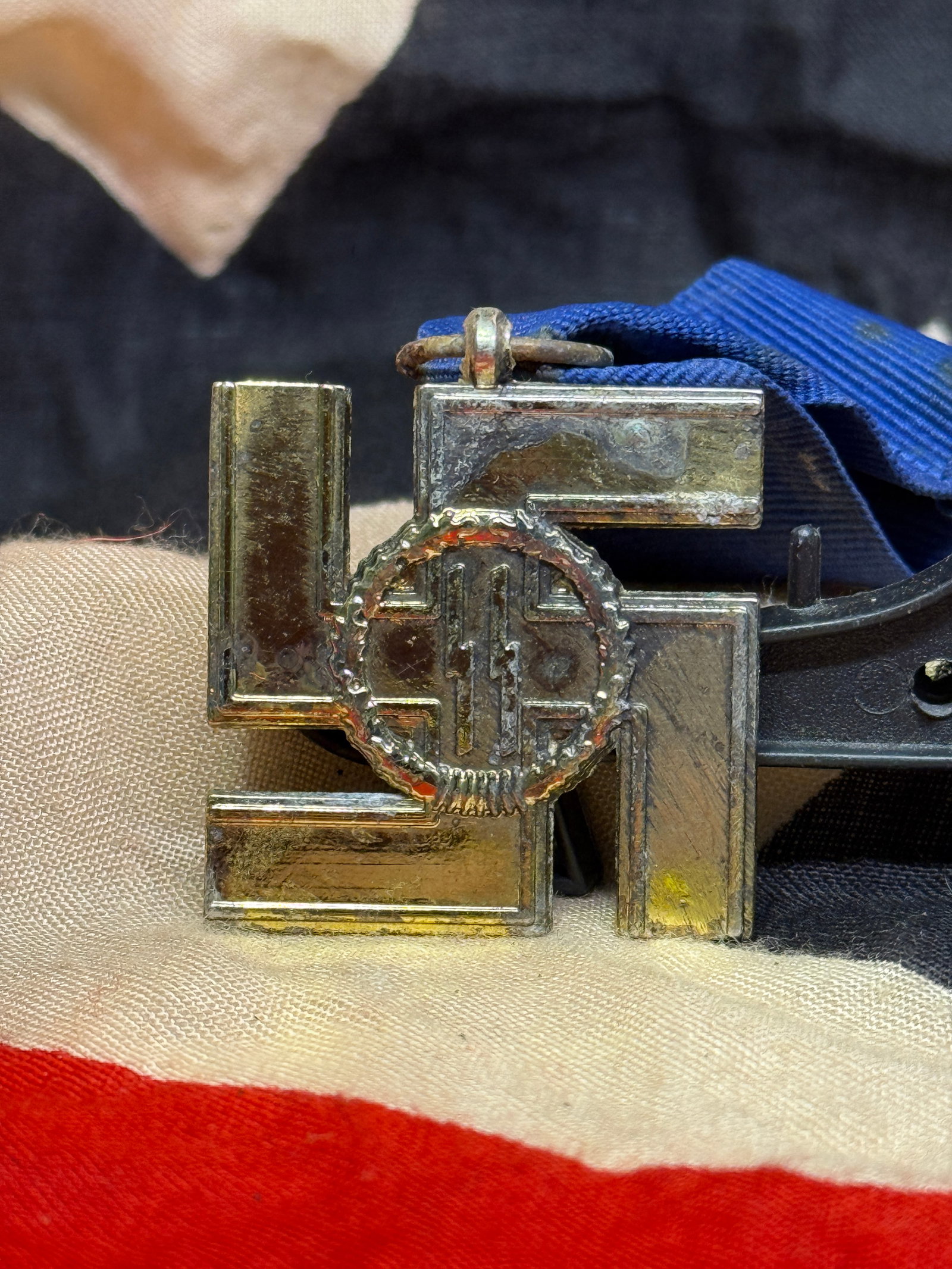 WWII German SS 12-Year Long Service Award Medal: This cross-shaped SS Long Service Award was presented to members of the Schutzstaffel (SS) in recognition of twelve years of faithful service. The obverse displays the SS runes within an oak wreath, w