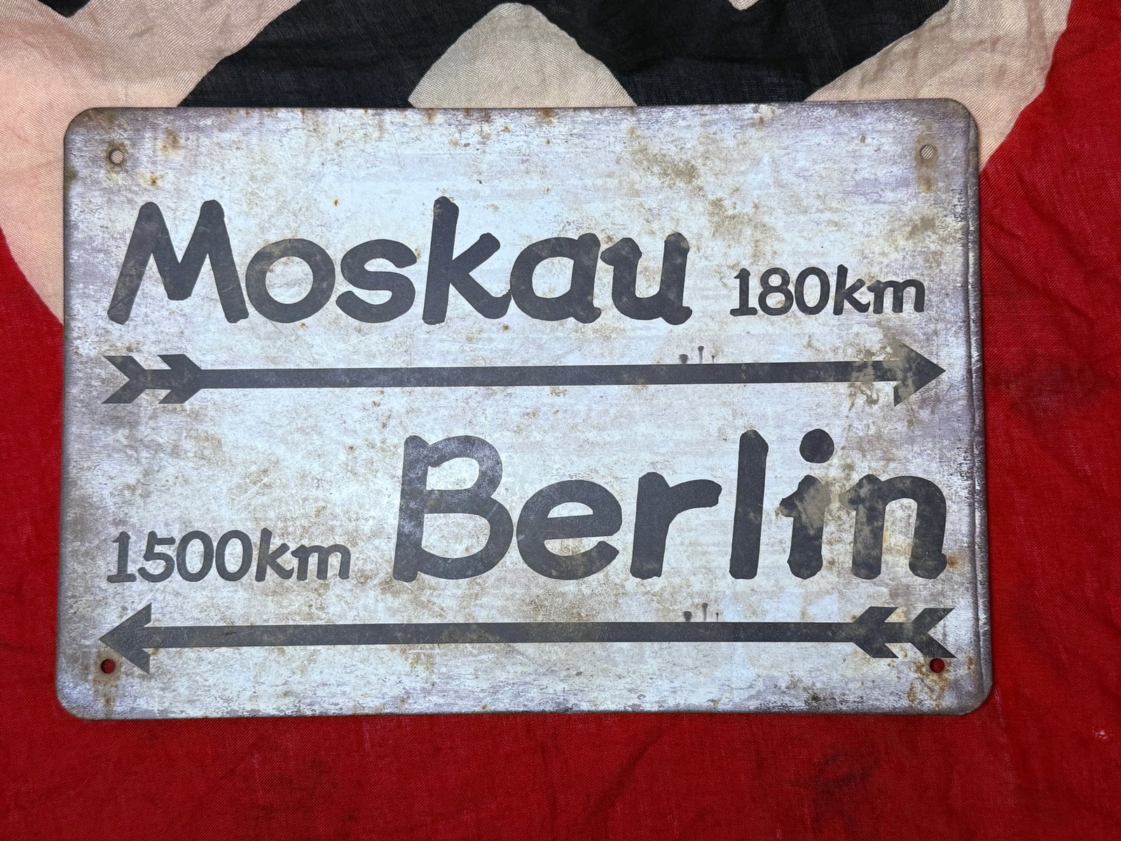 WWII German Eastern Front “Moskau–Berlin?? Road Sign: Rectangular German directional road sign referring to Moscow and Berlin, two cities central to the geography and propaganda of Germany’s war in the East. The upper inscription reads “Moskau 180 km