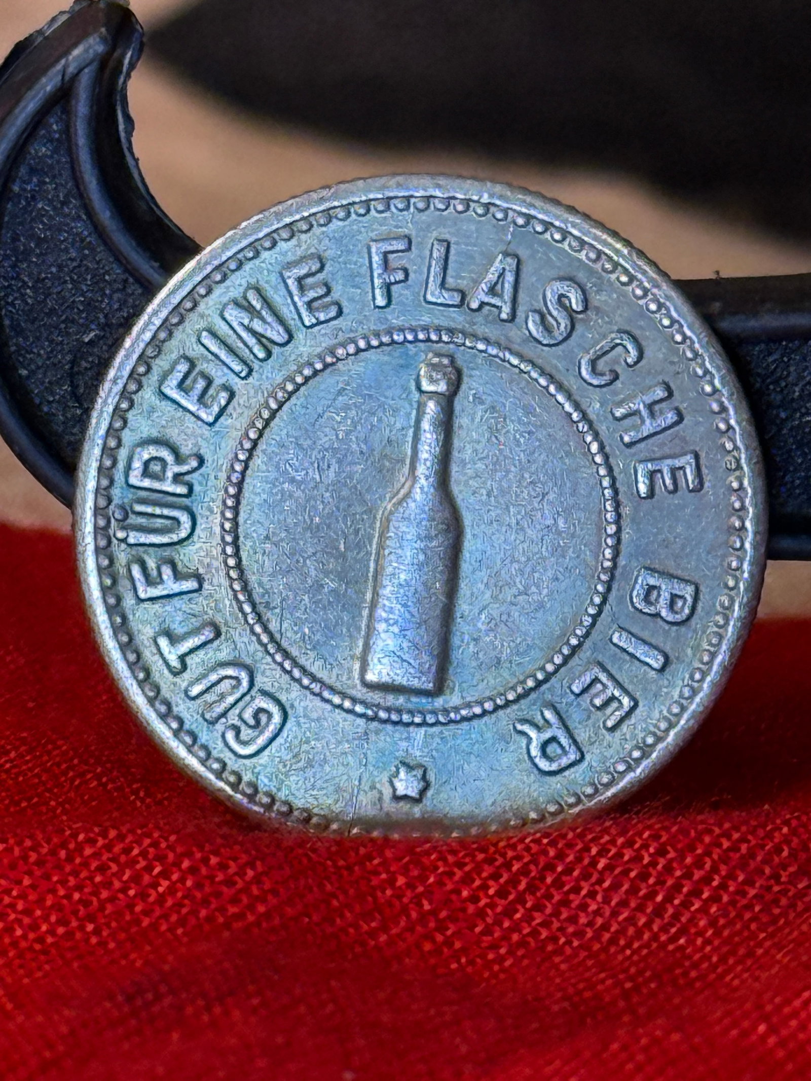 WWII German NSDAP Gauführerschule Beer Token: Round German institutional canteen token associated with an NSDAP Gauführerschule, or regional leadership school. One face bears a relief image of a bottle surrounded by the inscription “Gut für e