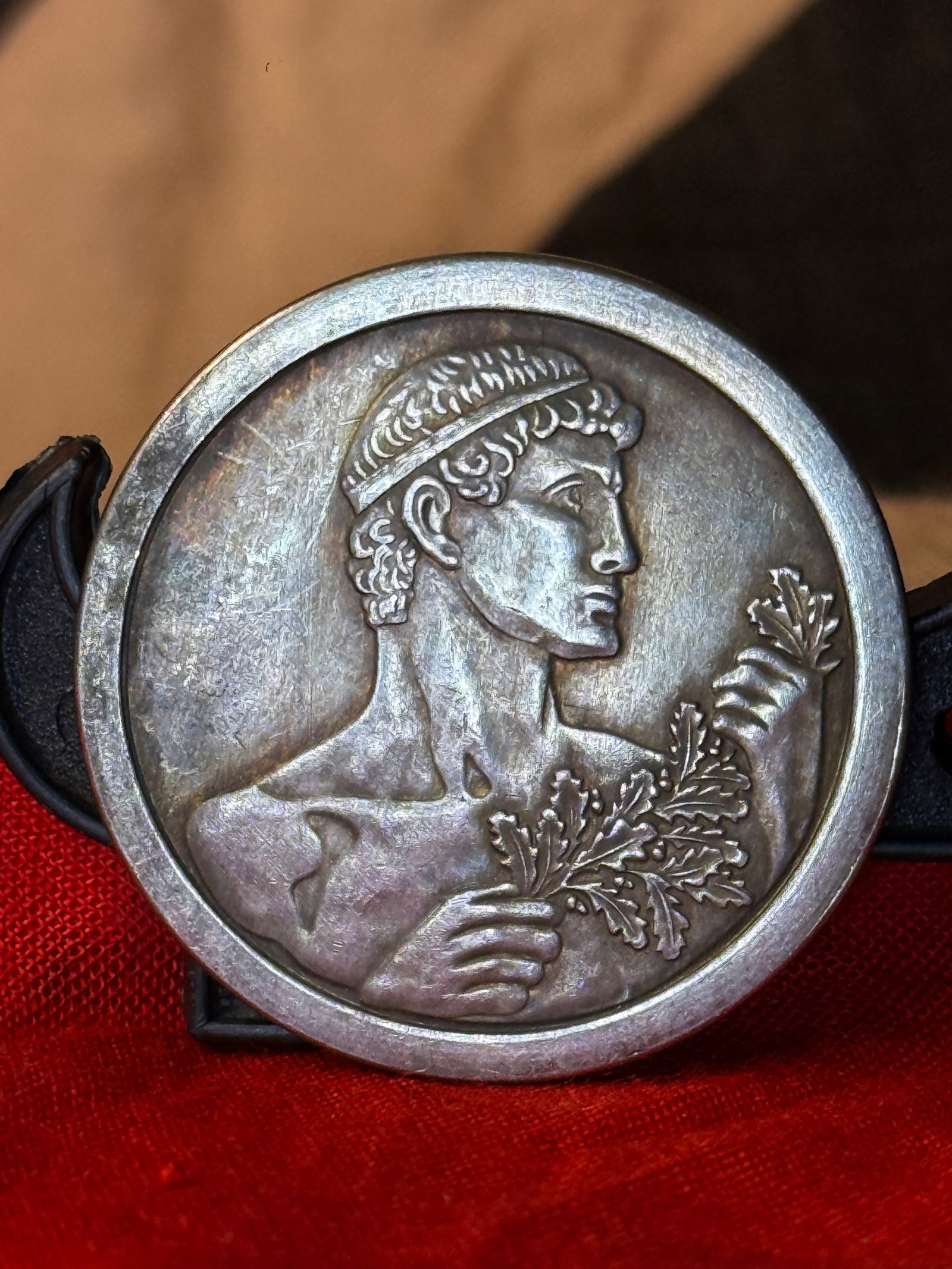 WWII German General Government 1942 Championship Medal: Circular silver-colored award medal associated with the German-administered General Government in occupied Poland. The obverse presents a classical male figure in profile wearing a narrow headband and