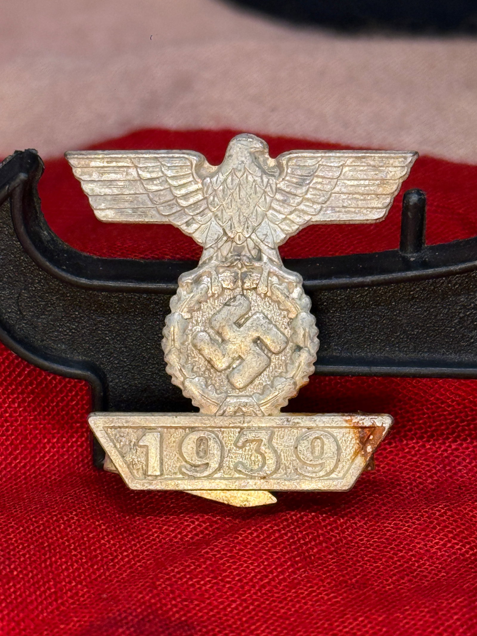 WWII German 1939 Clasp to the 1914 Iron Cross, Second Class — L/12 Marked: Metal uniform clasp awarded to recipients of the 1914 Iron Cross, Second Class, who received the decoration again during WWII. Its face presents a spread-winged German eagle above a wreath and swastik