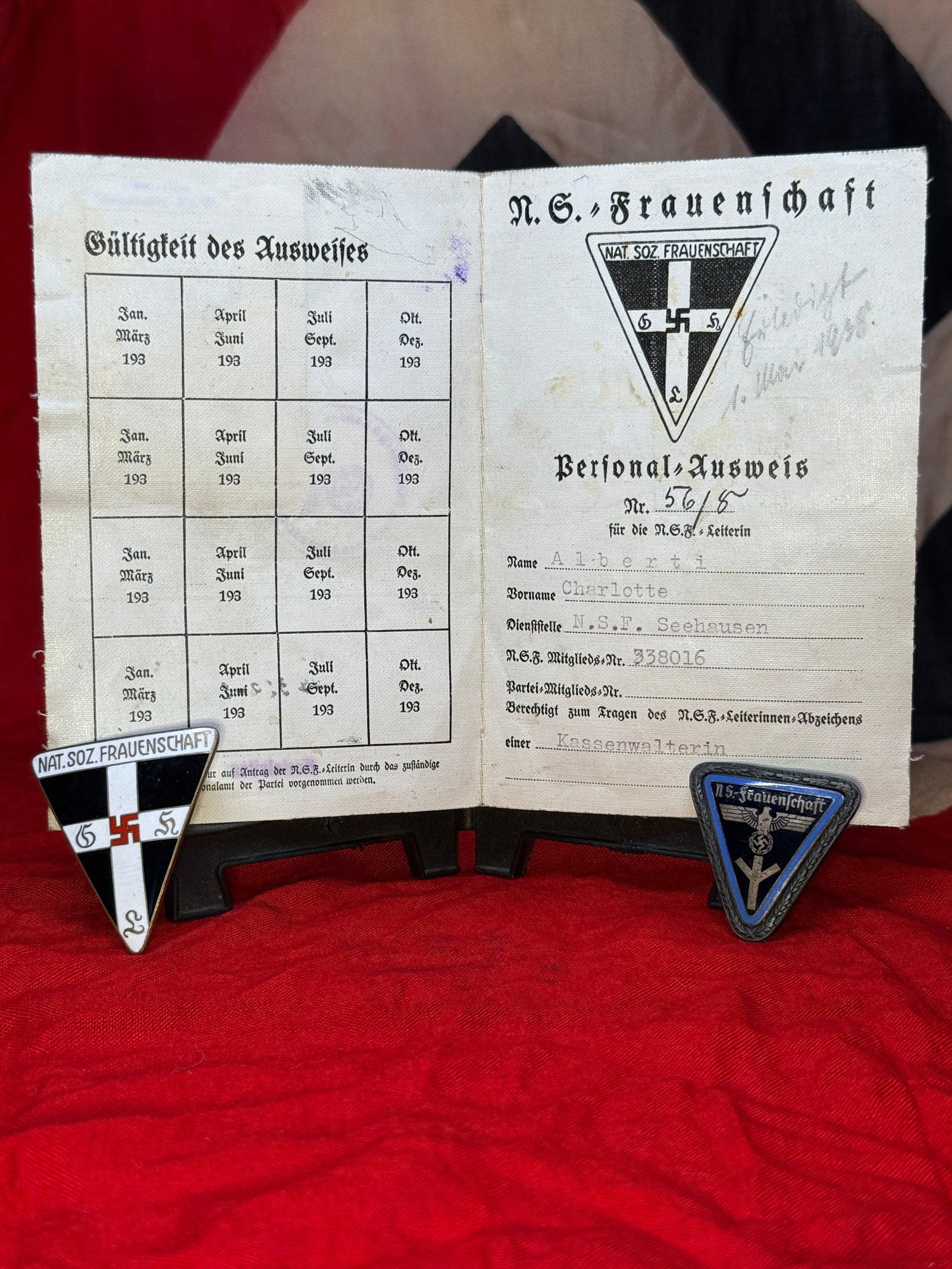 Pre-WWII German NS-Frauenschaft Identification and Insignia Grouping, Charlotte Alberti, 1936: Three-piece National Socialist Women’s League grouping consisting of a cloth-covered personnel identification booklet and two enameled organizational badges. The booklet was issued to Charlotte Albe