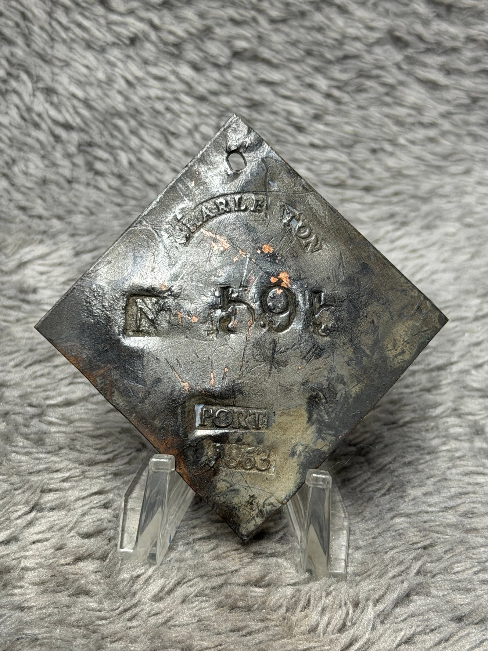 Charleston Porter Tag No. 595 Dated 1863 Diamond-Shaped Copper Badge: Diamond-shaped copper tag with a suspension hole near the upper point and stamped markings including “CHARLESTON” along the top, “No. 595” at center, “PORTER” below, and the da