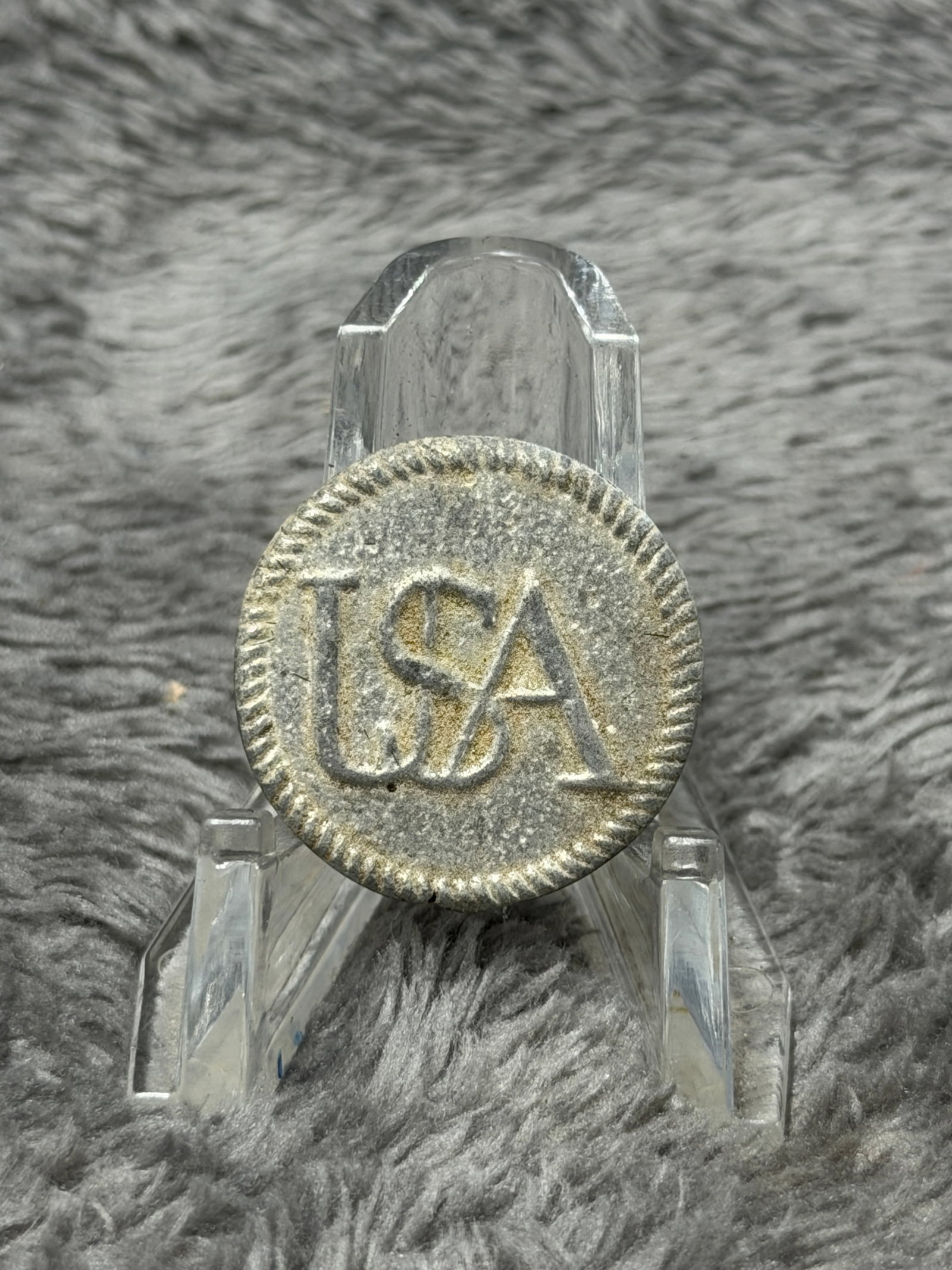Revolutionary War USA Pewter Coat Button Raised USA Lettering Military Style: Round pewter-toned coat button featuring raised intertwined “USA” lettering across the face with a decorative lined border around the outer edge. The reverse has a single integral-style shank 