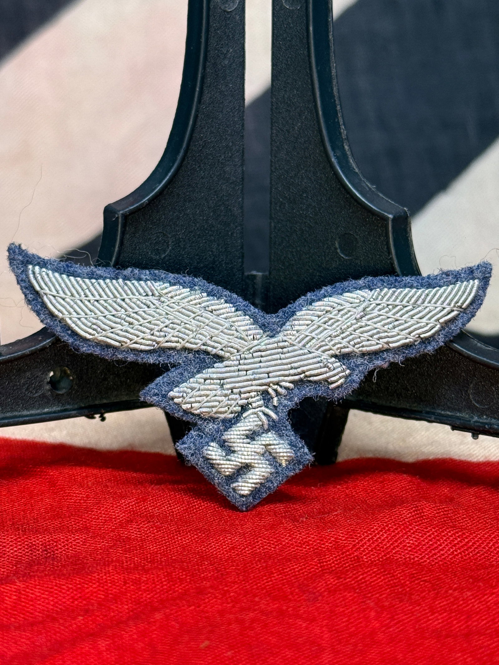 WWII German Luftwaffe Officer’s Bullion Cap Eagle Insignia: Fine silver bullion-embroidered Luftwaffe eagle mounted on Luftwaffe blue-grey wool backing. The detailed hand-worked eagle is presented with outstretched wings and a swastika below its talons, intend