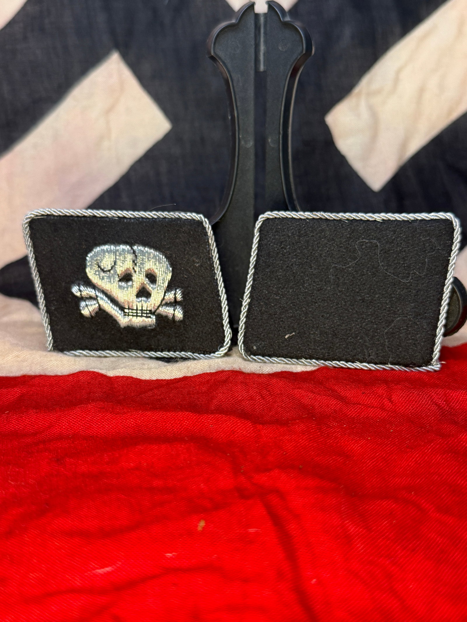 WWII German Waffen-SS Totenkopf Collar Tabs Pair With RZM Paper Tag: This black wool collar tab is embroidered with the silver-gray Totenkopf (Death's Head) skull and crossbones motif associated with the Waffen-SS. The reverse retains its original black backing and per