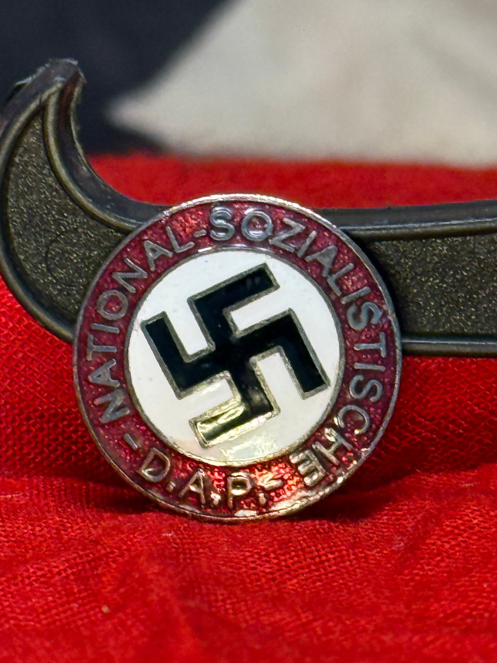WWII German NSDAP Membership Badge RZM M1/129: This WWII German NSDAP Party Membership Badge features the black swastika on a white enamel field surrounded by a red enamel border inscribed "National-Sozialistische D.A.P." The reverse retains its h