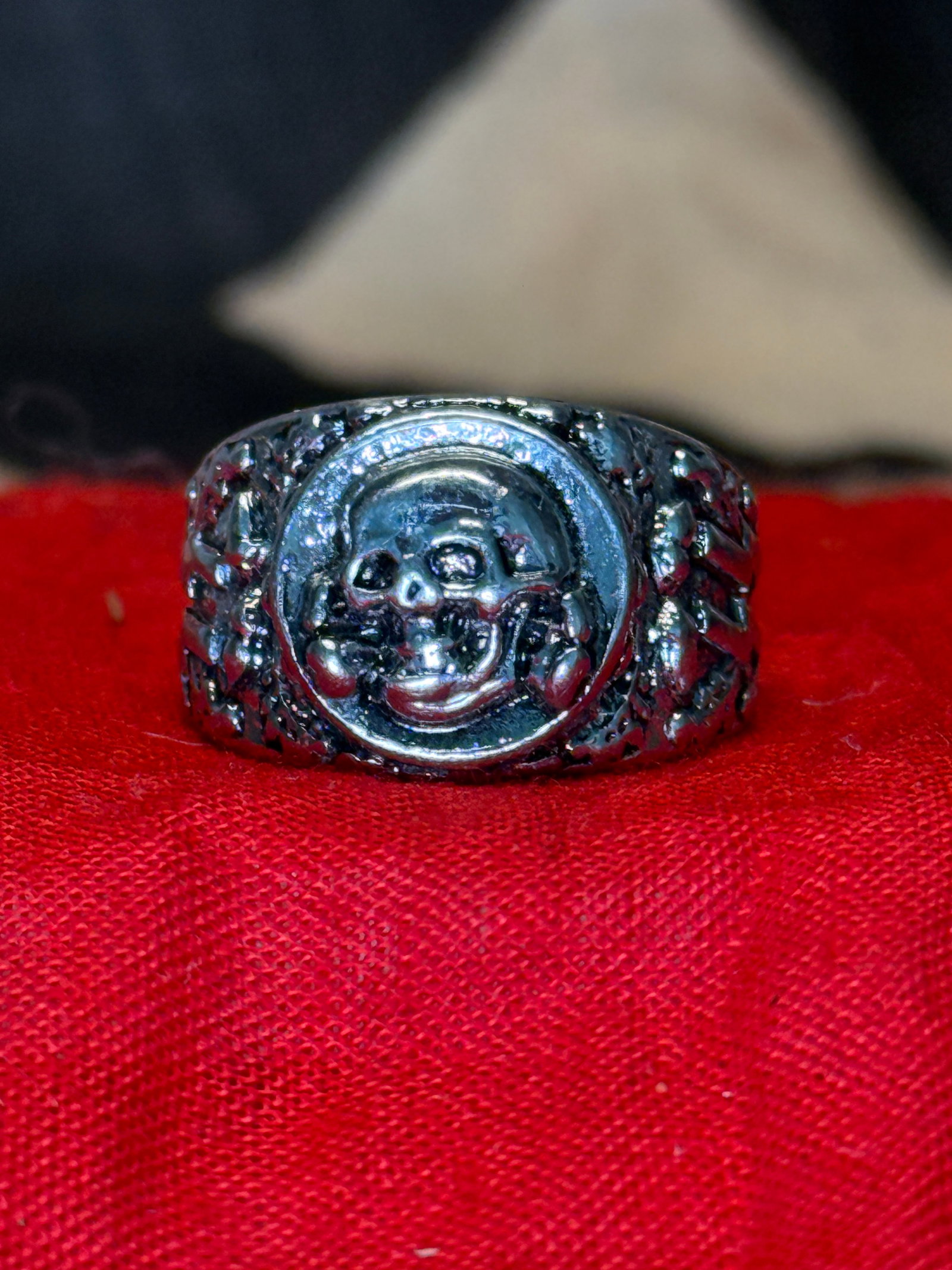 WWII German Waffen-SS Totenkopf Silver Ring: This WWII German Waffen-SS Totenkopf Ring features a prominent skull and crossbones motif on the bezel with decorative oak leaf styling extending along the shoulders of the band. The Totenkopf, or "De