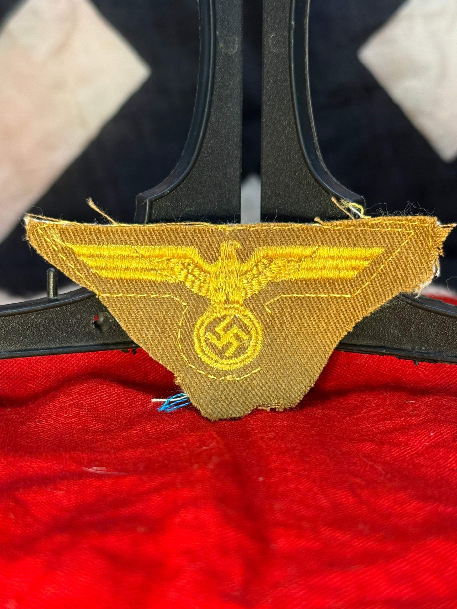 WWII German Kriegsmarine Tropical Breast Eagle Insignia: This embroidered cloth breast eagle features the national eagle with outstretched wings grasping a wreath enclosing a swastika, executed in golden-yellow thread on a tan tropical backing. Intended for
