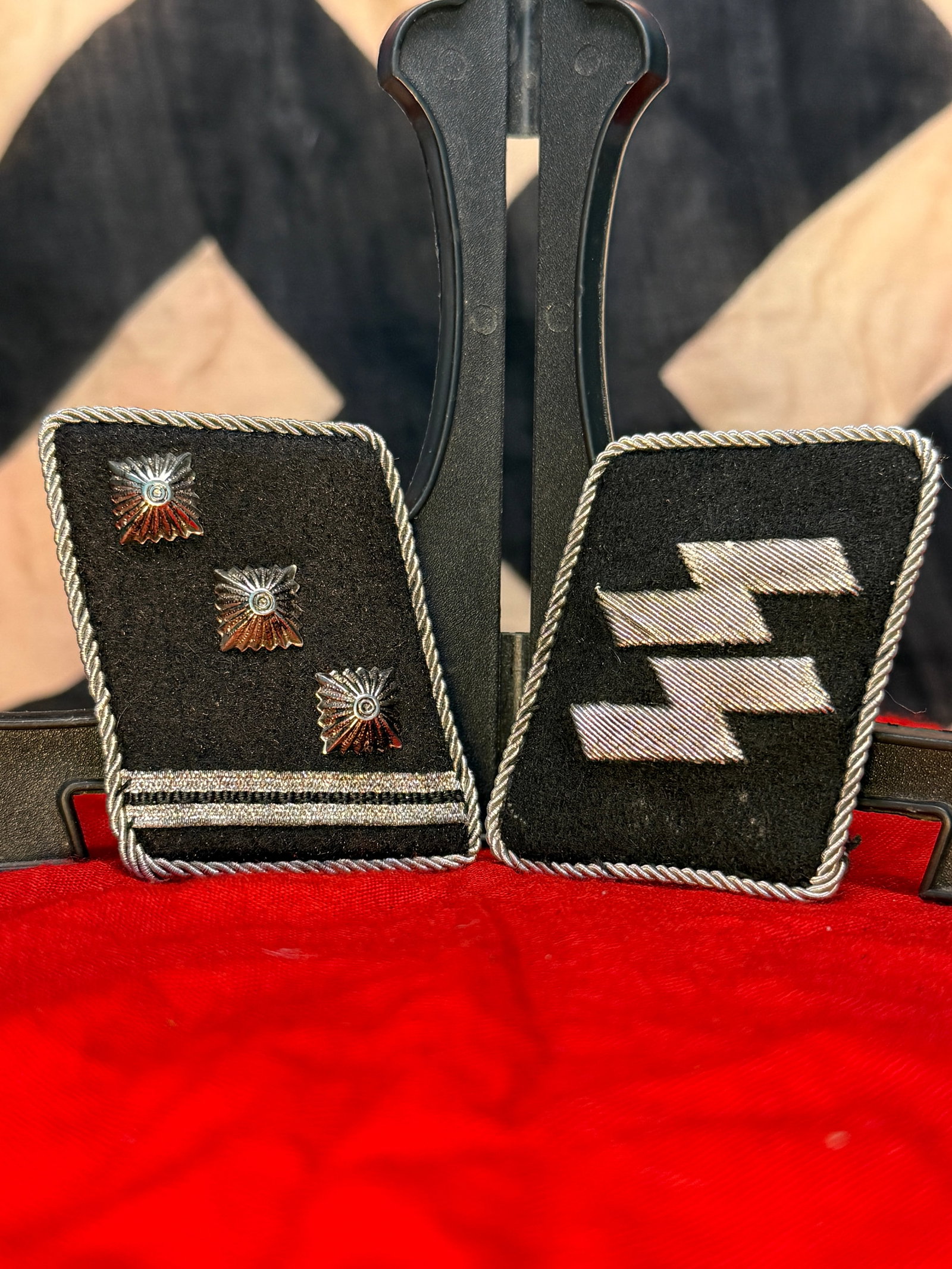 WWII German Waffen-SS Sturmbannführer Collar Tabs With RZM Paper Tag: This matched set of black wool Waffen-SS collar tabs consists of a rank tab bearing three silver pips and silver braid denoting the rank of Sturmbannführer (Major), paired with the opposing runic SS 