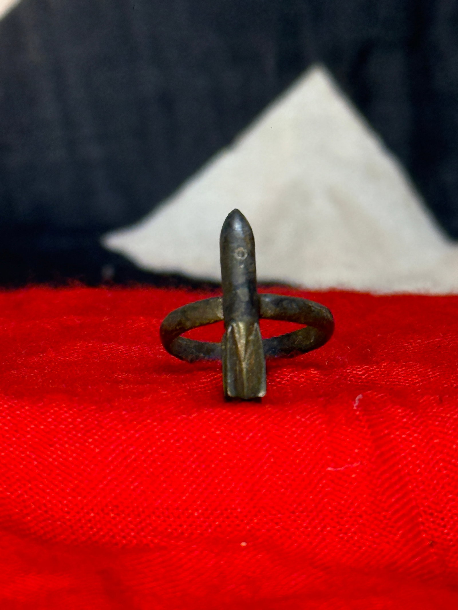 WWII German U-Boat Bomber’s Missile Ring – Submarine Crew Military Jewelry: A distinctive WWII German U-Boat themed ring fashioned with a miniature missile or torpedo-shaped centerpiece mounted vertically across a simple circular band. The elongated centerpiece features a poi