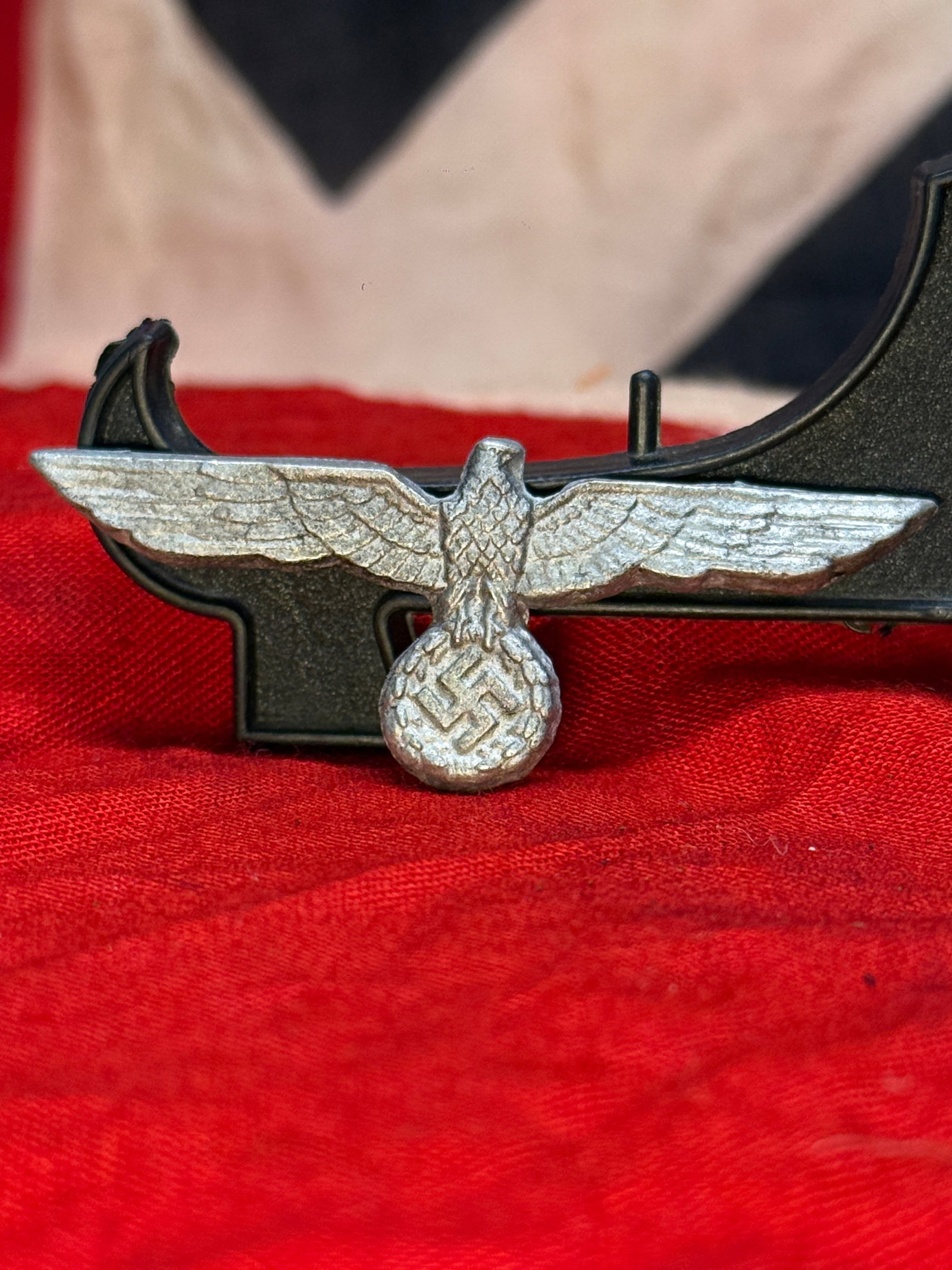 WWII German Wehrmacht Heer Army Visor Cap Eagle Insignia: This die-struck aluminum cap insignia features the spread-wing Wehrmacht Heer national eagle clutching a wreath enclosing a swastika, the standard emblem worn on German Army visor caps during the Seco