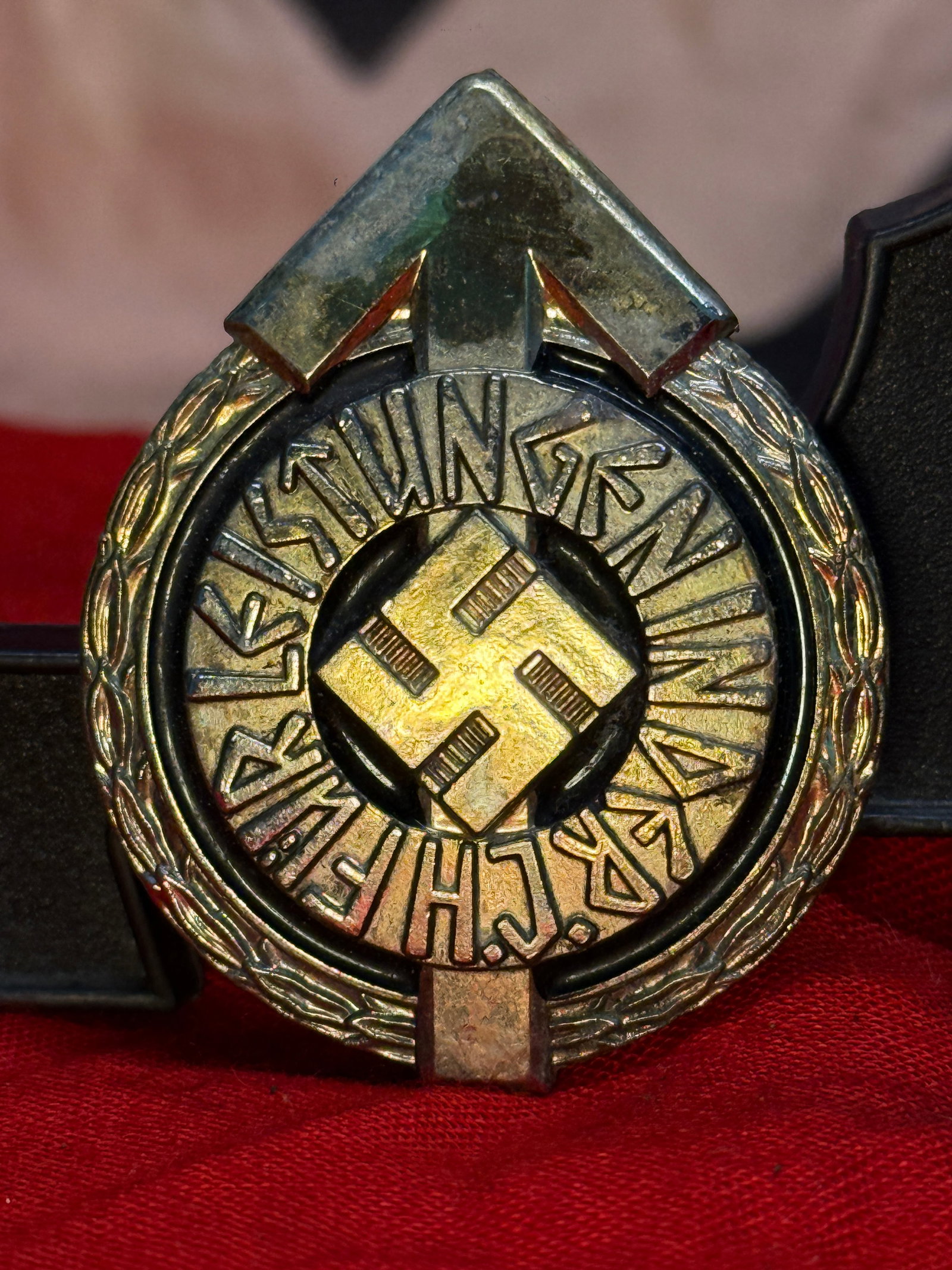 WWII German Reichsnährstand Membership Badge Serial Number 2223 RZM M1/101: This circular gilt-finished membership badge features a central swastika surrounded by the inscription "Reichsnährstand" within an ornamental wreath. The reverse retains its original vertical pin ass