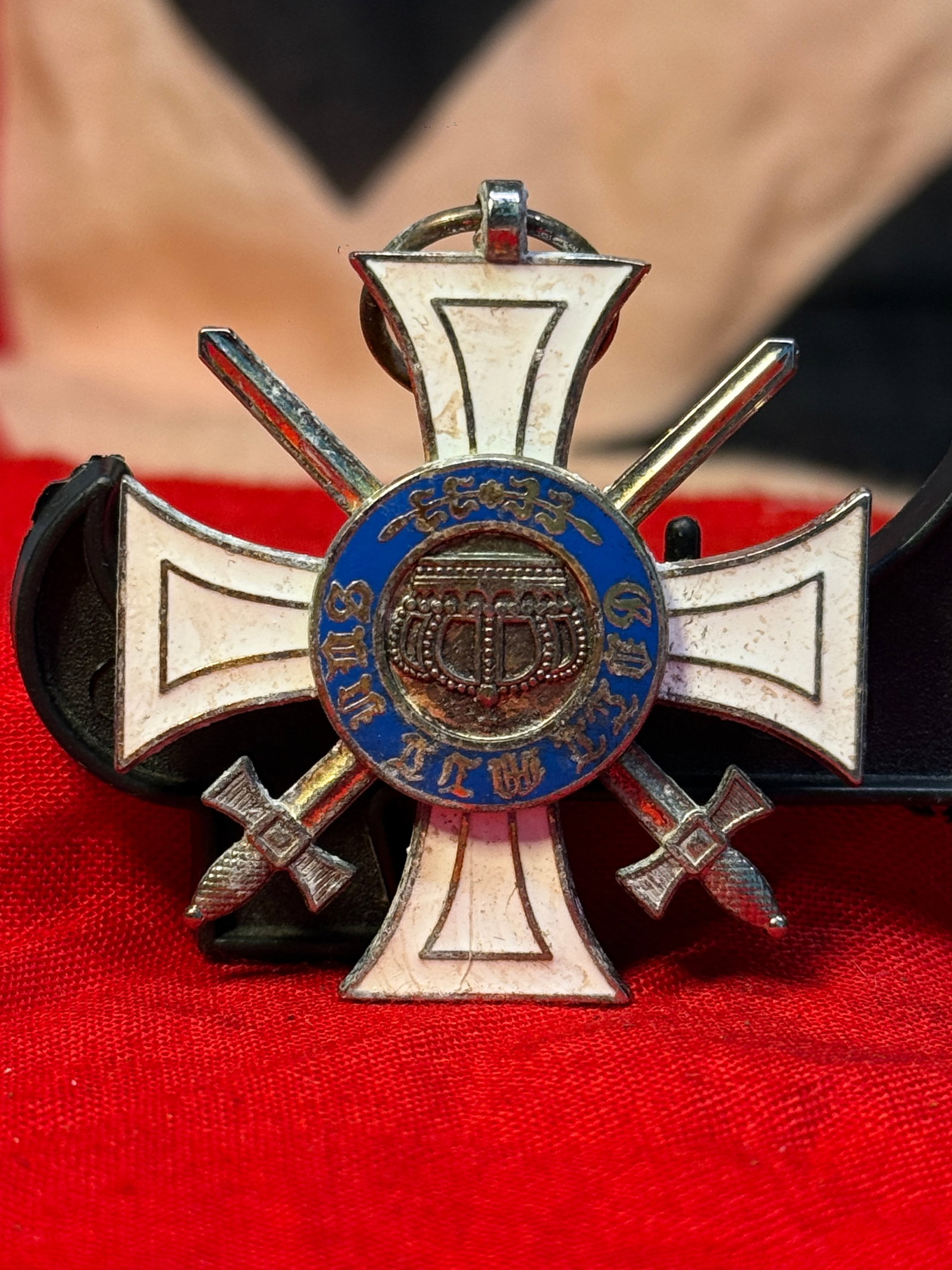 WWI Imperial German Prussian Order of the Crown with Swords: This elegant white enameled cross features crossed swords between the arms and a blue center medallion with a crowned royal cipher, suspended from its original loop. The reverse displays an additional