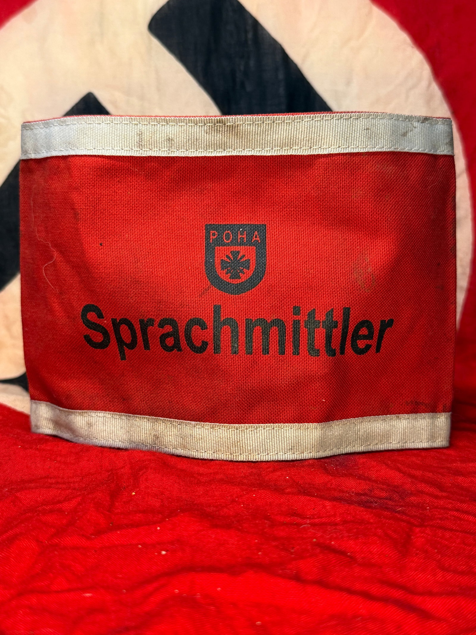 WWII German Third Reich DRK Sprachmittler Translator Armband: This red cloth armband is printed with the DRK (Deutsches Rotes Kreuz) emblem above the word "Sprachmittler," the German term for "Translator" or "Interpreter." Intended for personnel serving as trans