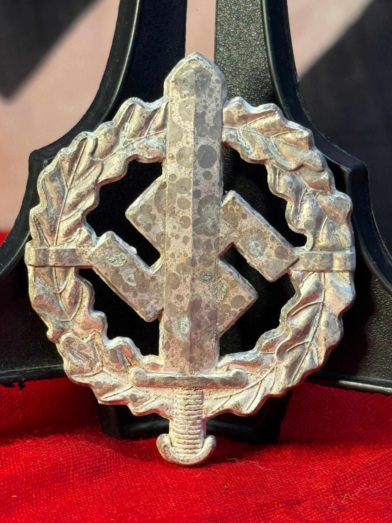 WWII German SA Sports Badge (SA-Sportabzeichen): This WWII German SA Sports Badge features a vertical sword over a swastika enclosed within an oak leaf wreath, symbolizing achievement in the physical fitness program administered by the Sturmabteilun