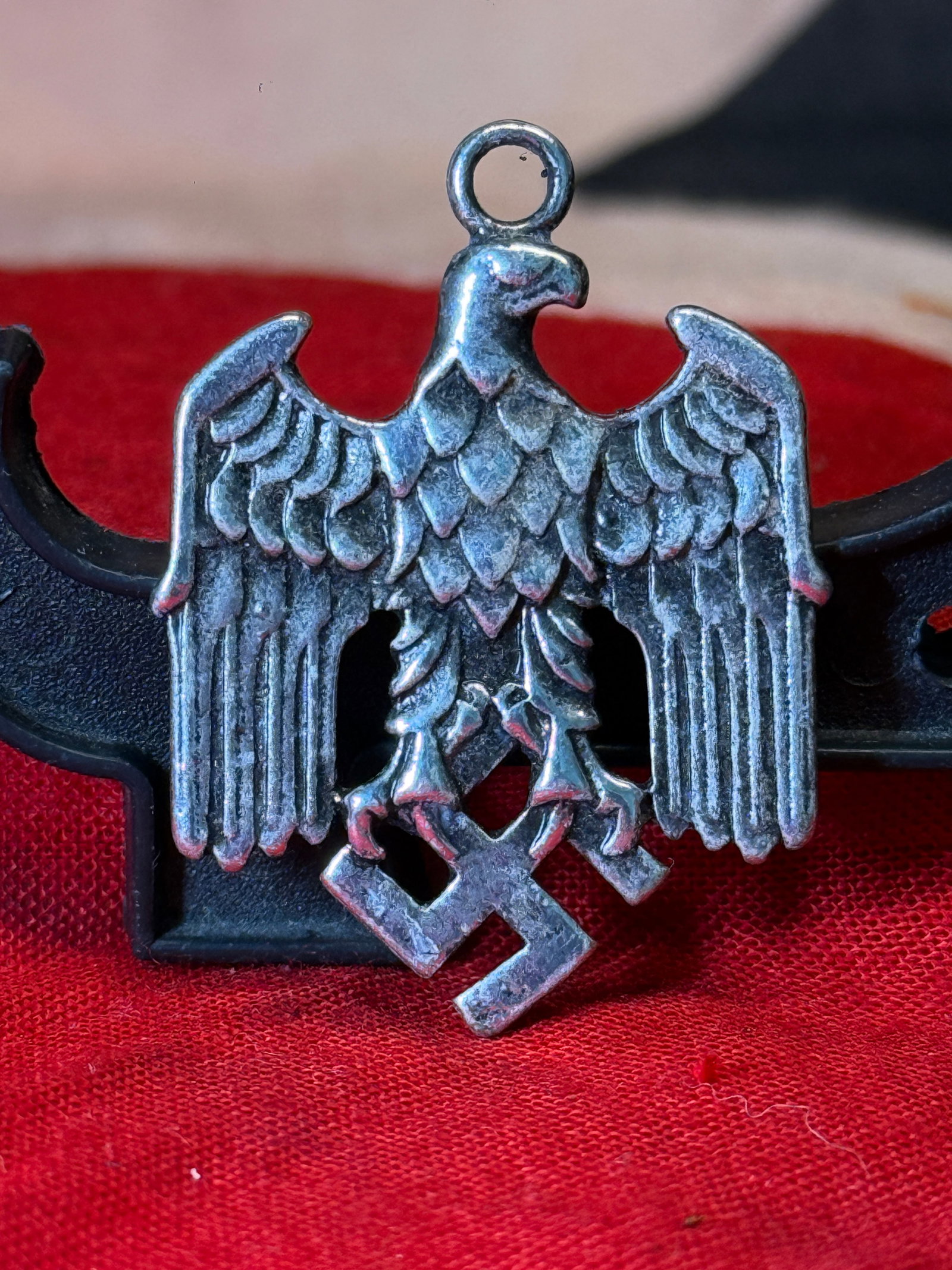 WWII German Third Reich Eagle & Swastika Pendant: This WWII German Third Reich eagle and swastika pendant features a finely cast national eagle clutching a swastika with an integral suspension loop for wear as a pendant or decorative accessory. The r