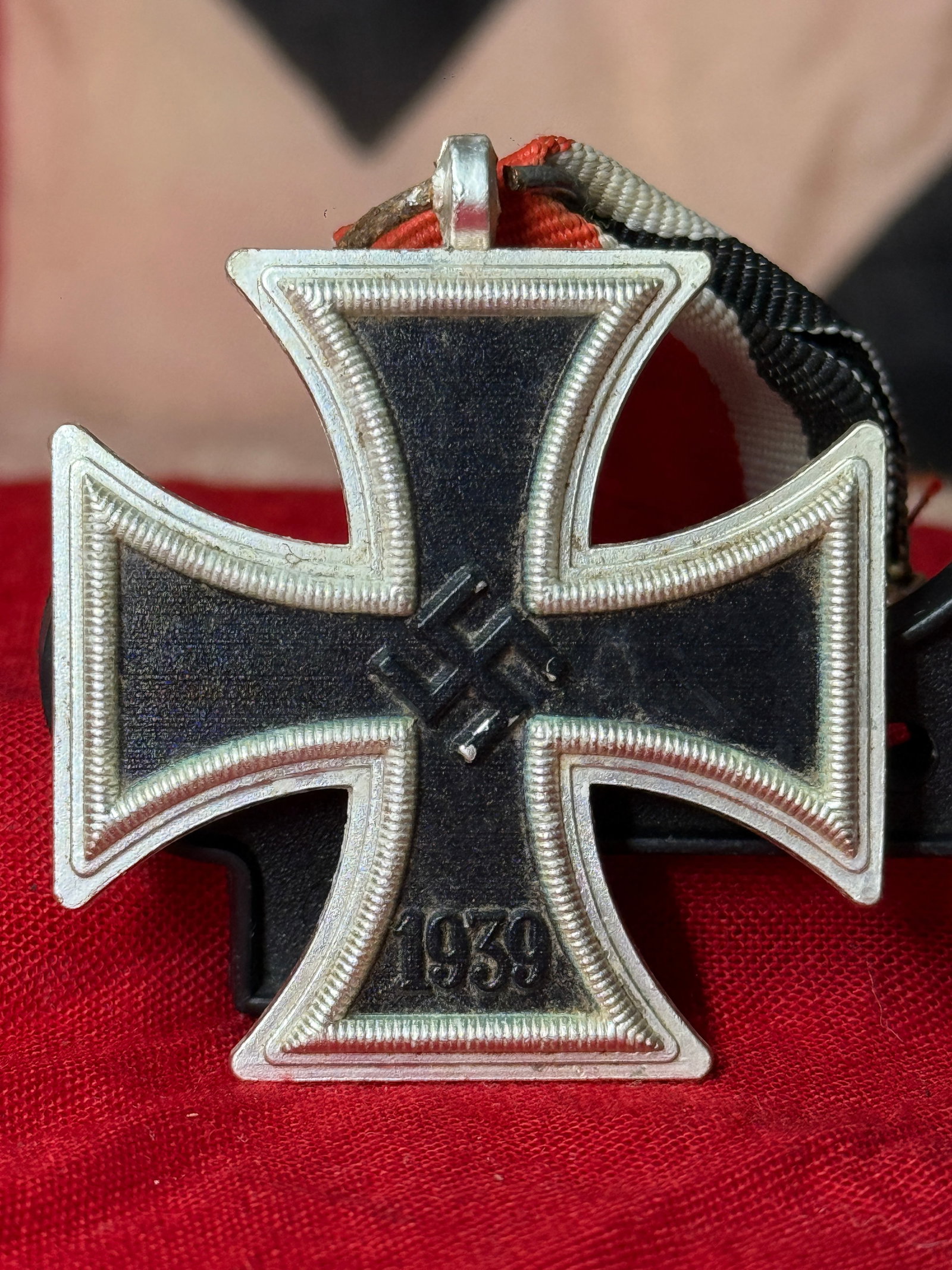 WWII German Iron Cross 2nd Class Medal: This WWII German Iron Cross 2nd Class Medal displays the 1939 date beneath a central swastika on the obverse and the traditional 1813 date on the reverse, suspended from its original black, white, and
