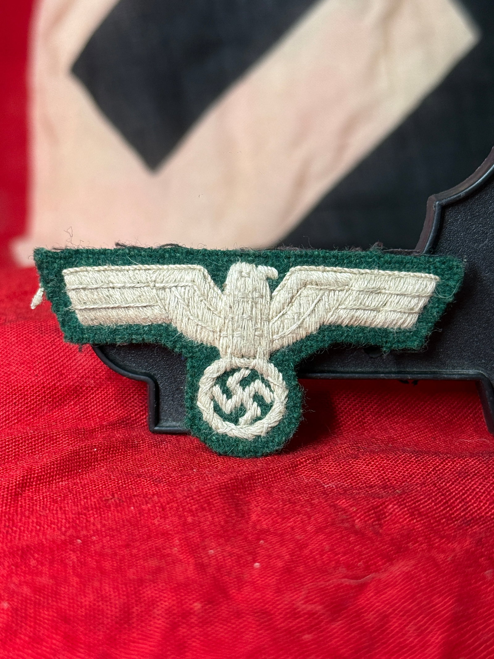 WWII German Heer Officer Bullion Breast Eagle Insignia: This WWII German Heer Officer bullion breast eagle insignia is hand embroidered in silver bullion thread on a dark green wool backing, depicting the national eagle clutching a wreath enclosing a swast
