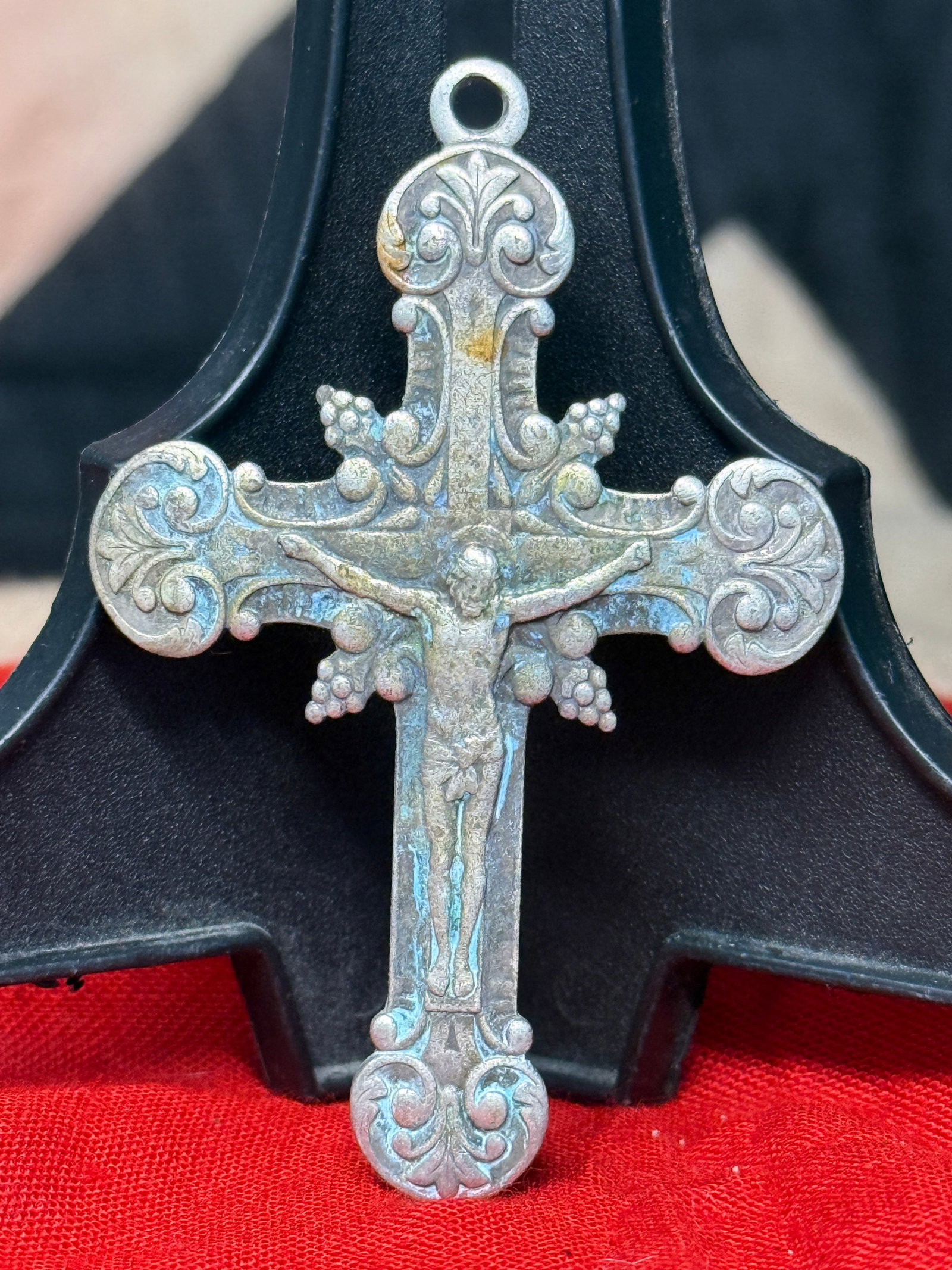 WWII German Silver Catholic Crucifix Pendant: This WWII German silver Catholic Crucifix Pendant features an ornate cross with a detailed figure of Christ on the obverse and multiple silver hallmarks, including an 835 silver purity mark, on the re