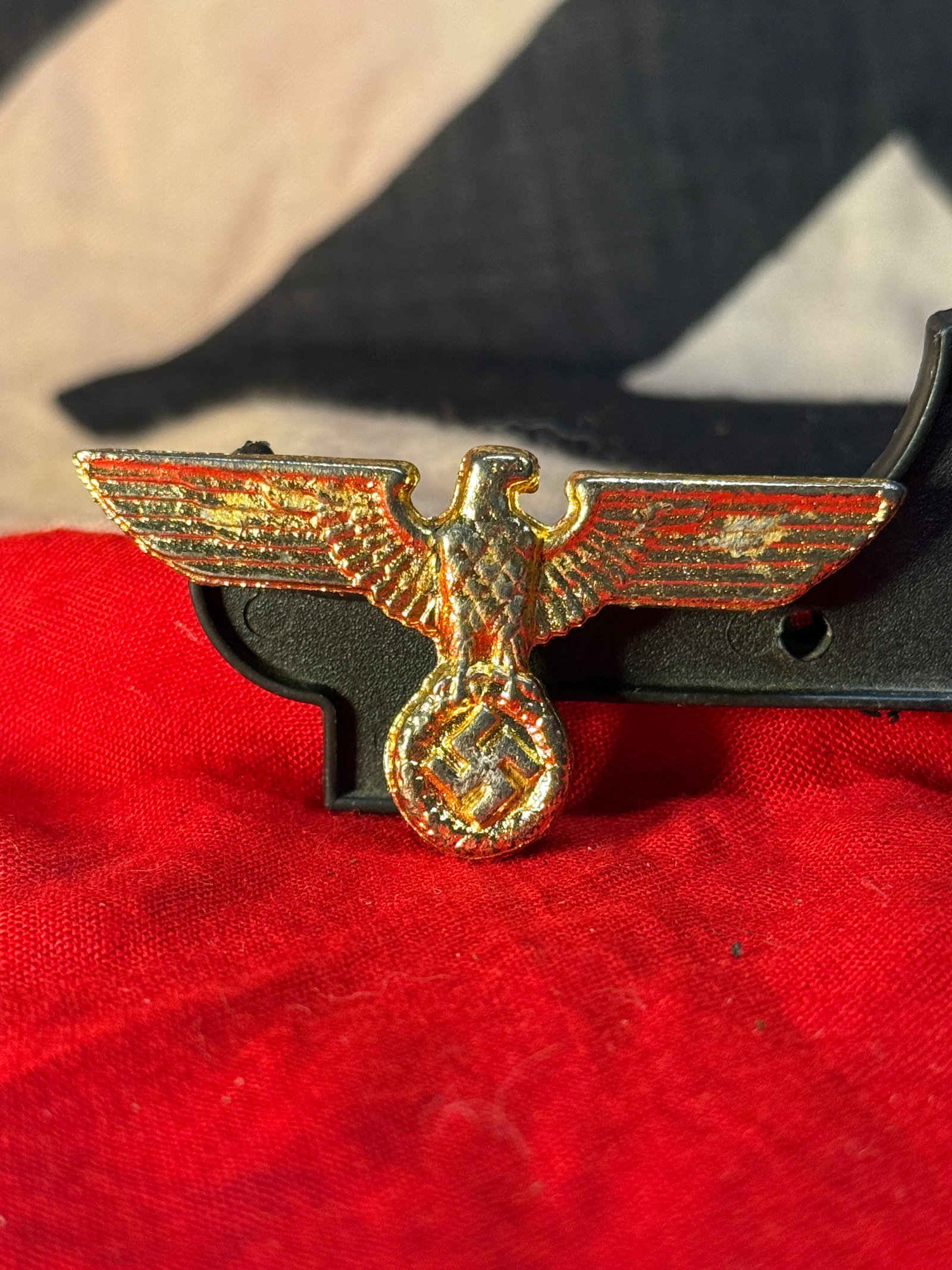 WWII German Wehrmacht Army Breast Eagle Insignia: This WWII German Wehrmacht Army Breast Eagle features the national eagle with outstretched wings clutching a wreathed swastika, executed in a gold-colored metal finish. Breast eagles of this style wer