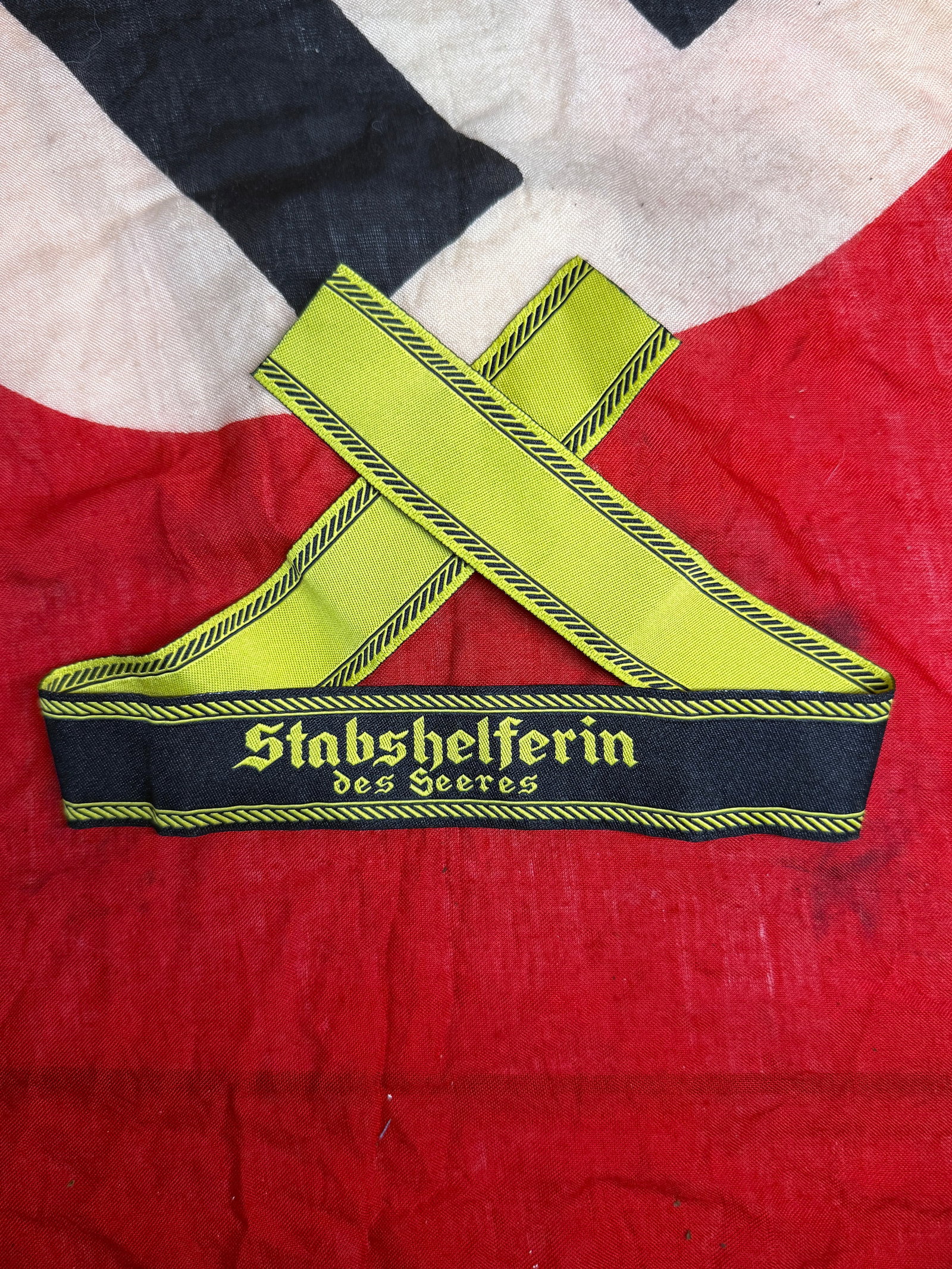 WWII German Army Stabshelferin des Heeres Cuff Title: This WWII German Army Stabshelferin des Heeres Cuff Title is woven in black with yellow Gothic script reading "Stabshelferin des Heeres" and finished with matching decorative borders. It was worn by f