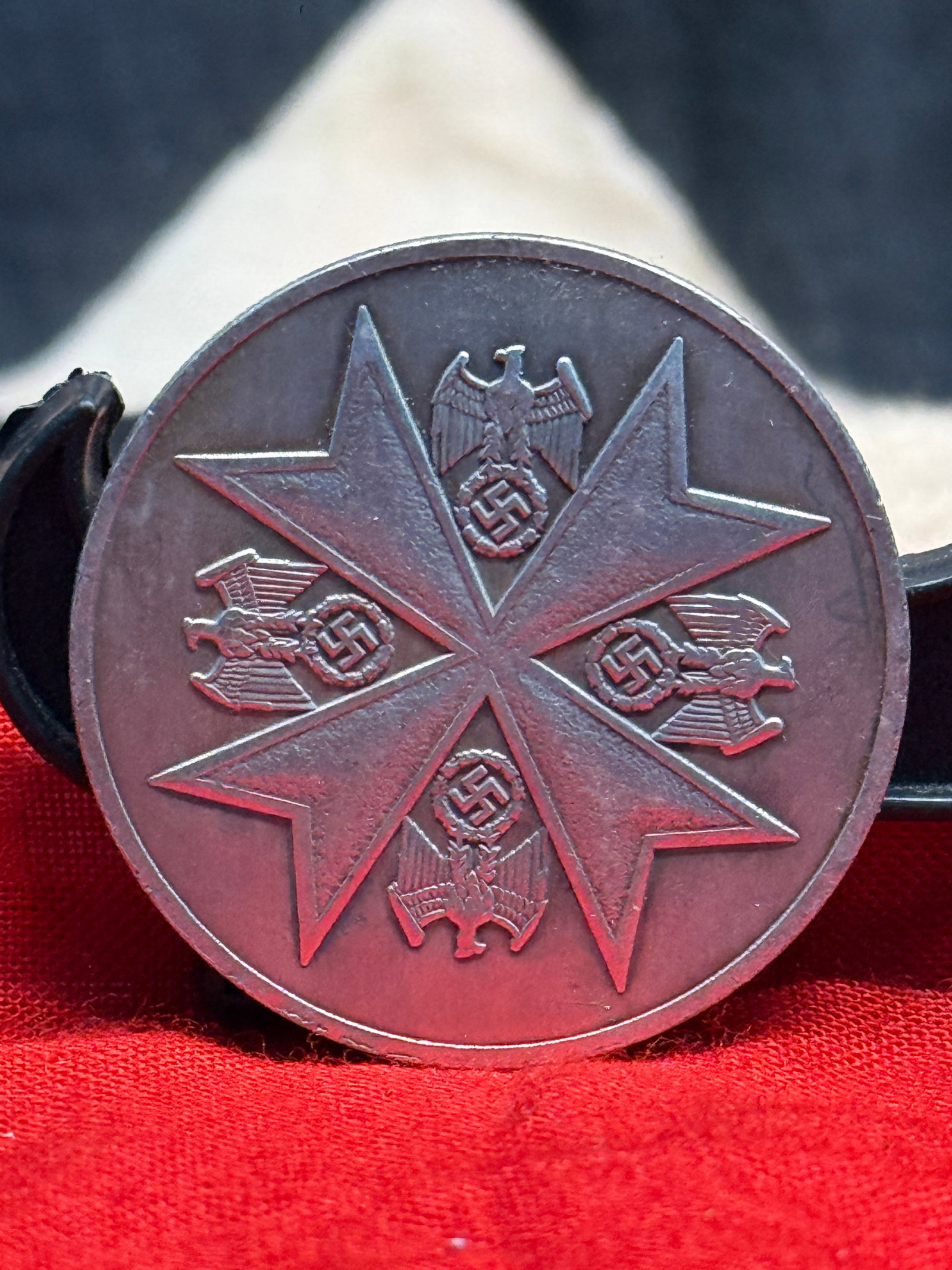 WWII German Deutsche Verdienst-Medaille Commemorative Medal: This WWII German Deutsche Verdienst-Medaille Commemorative Medal features a large Maltese cross surrounded by emblems representing the various branches of the German armed forces on the obverse, while