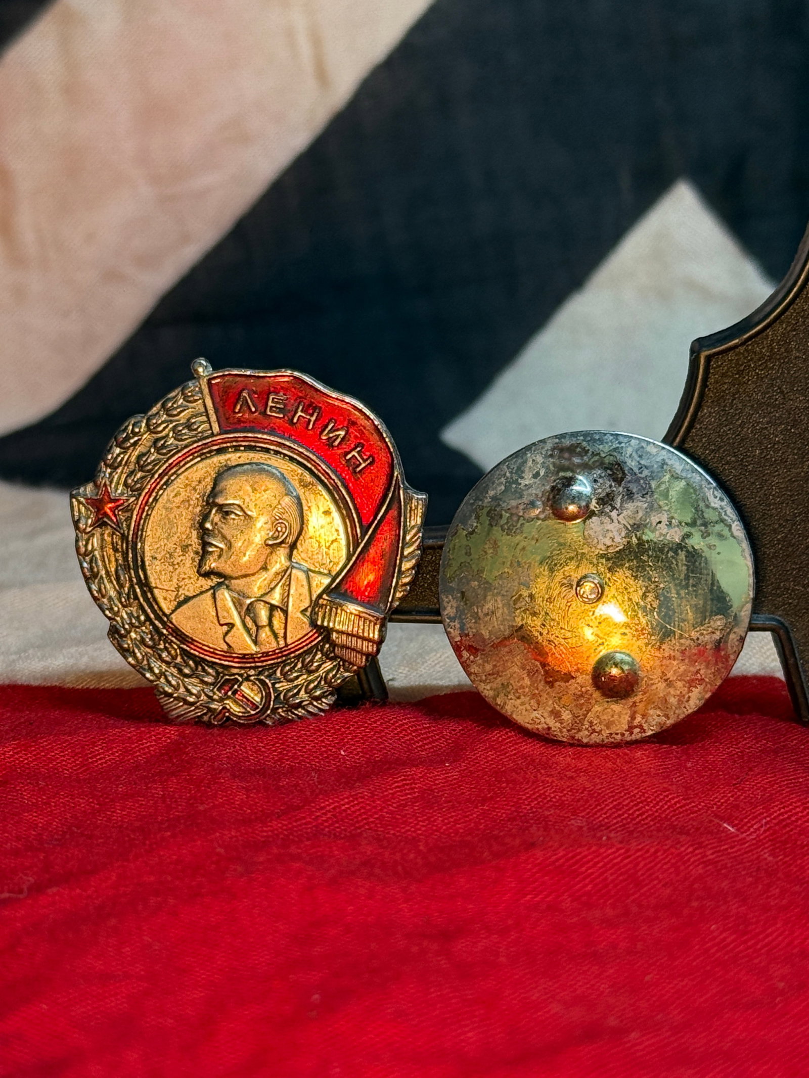 WWII Soviet Vladimir Lenin Communist Membership Badge: This enameled Soviet membership badge features a left-facing portrait of Vladimir Lenin framed by a red banner inscribed "?????" (Lenin) in Cyrillic. A laurel wreath, red star, and hammer and sickle c