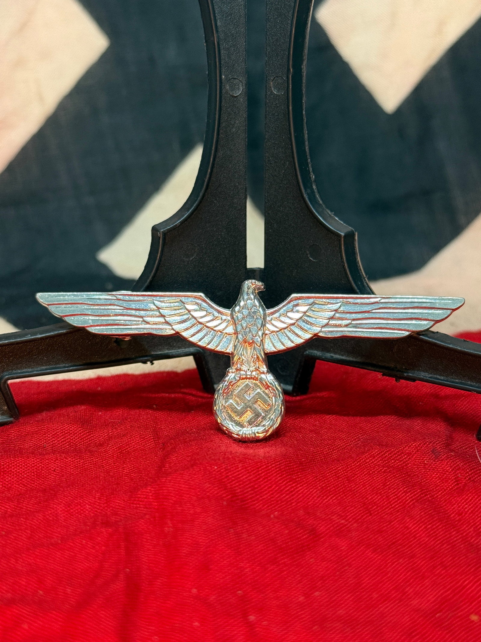 WWII German Heer Army Visor Cap Eagle Insignia: This silvered metal national eagle insignia was worn on the visor caps of the German Heer during World War II. The design features the spread-wing eagle clutching a wreath enclosing a swastika, one of