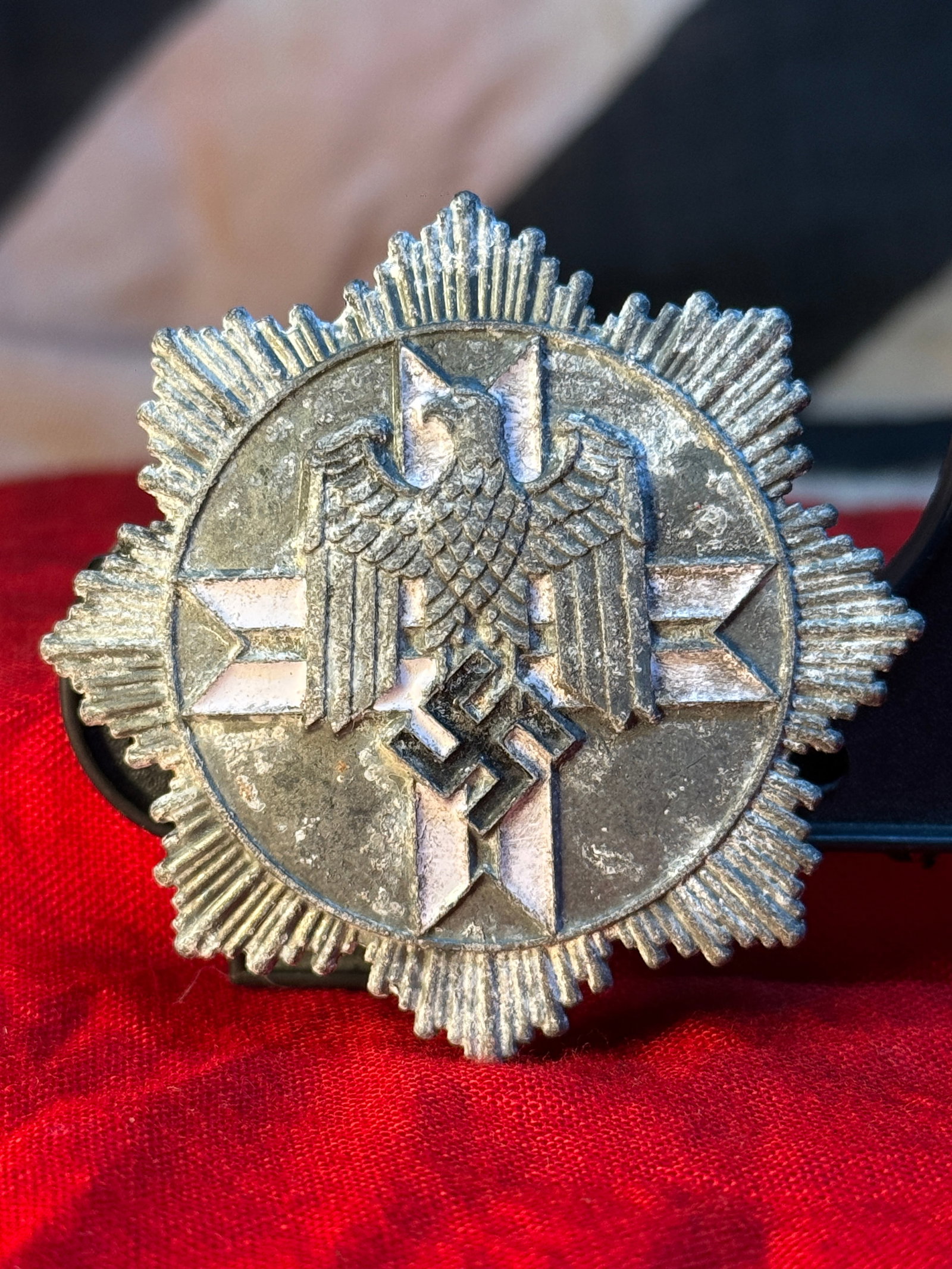 WWII German Reichsbund der Deutschen Beamten Membership Breast Badge: This silvered eight-pointed star-shaped membership badge features a German national eagle above a swastika set against a radiating starburst. The reverse retains its original screwback attachment engr