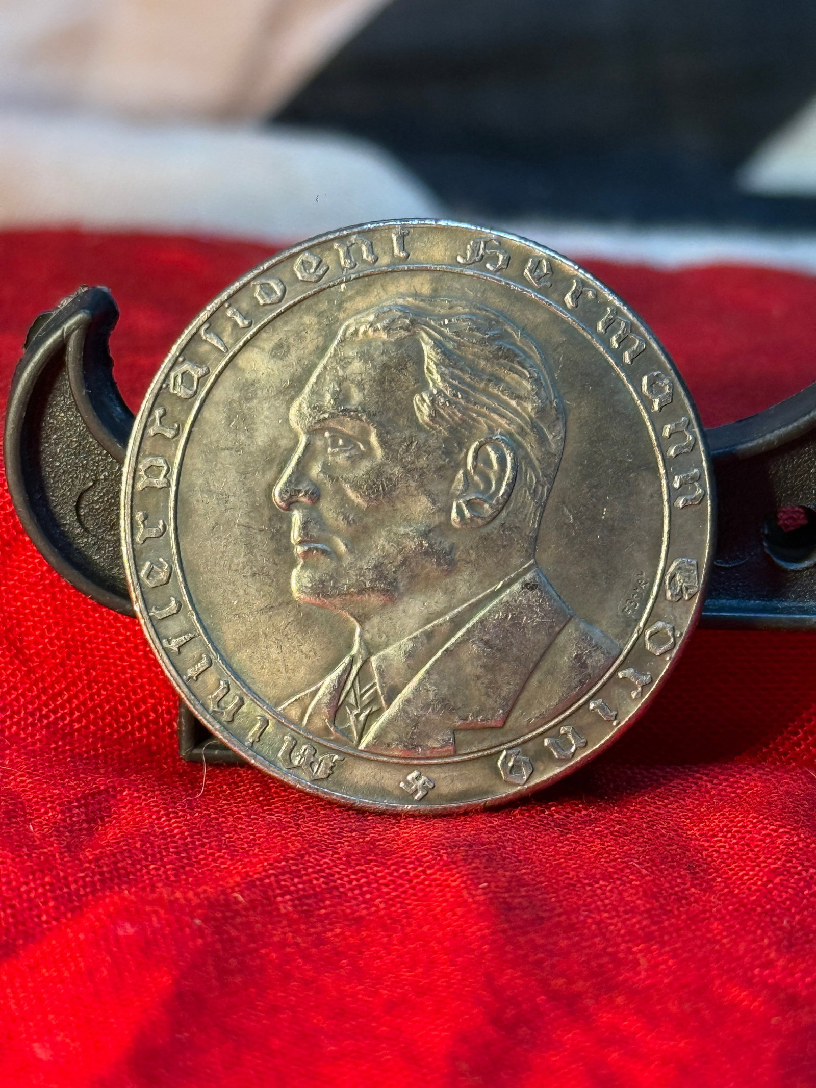 1933 German Adolf Hitler "Der Bildner Seiner Soldaten" Commemorative Medal: This silver-toned commemorative medal features a left-facing portrait of Adolf Hitler surrounded by the inscription "Der Bildner Seiner Soldaten." The reverse depicts a German national eagle holding a