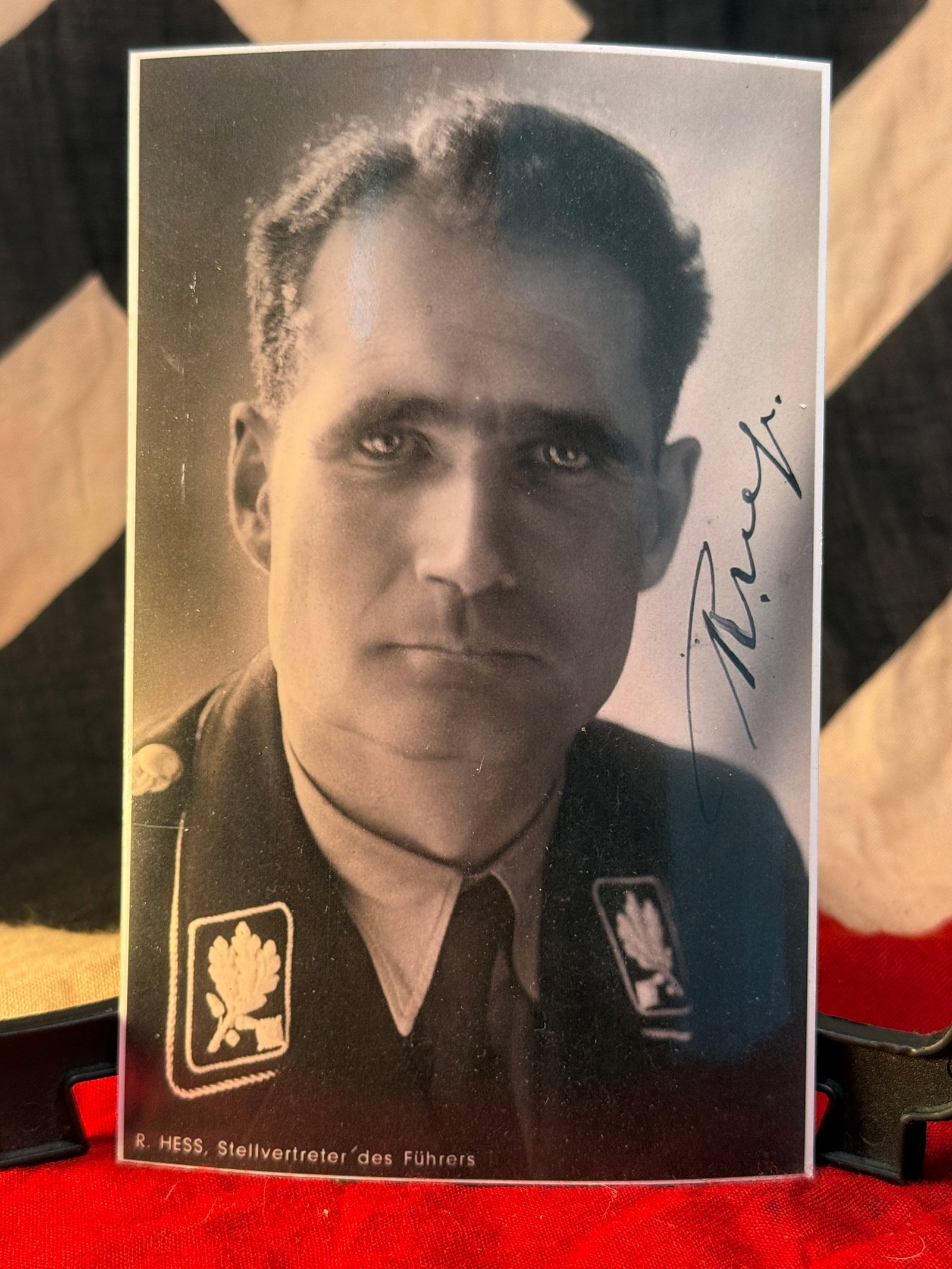 WWII German Rudolf Hess Portrait Signed Photograph: This black-and-white portrait depicts Rudolf Hess, identified along the lower border as "R. Hess, Stellvertreter des Führers" ("Deputy to the Führer"). Hess is shown wearing his political uniform wi