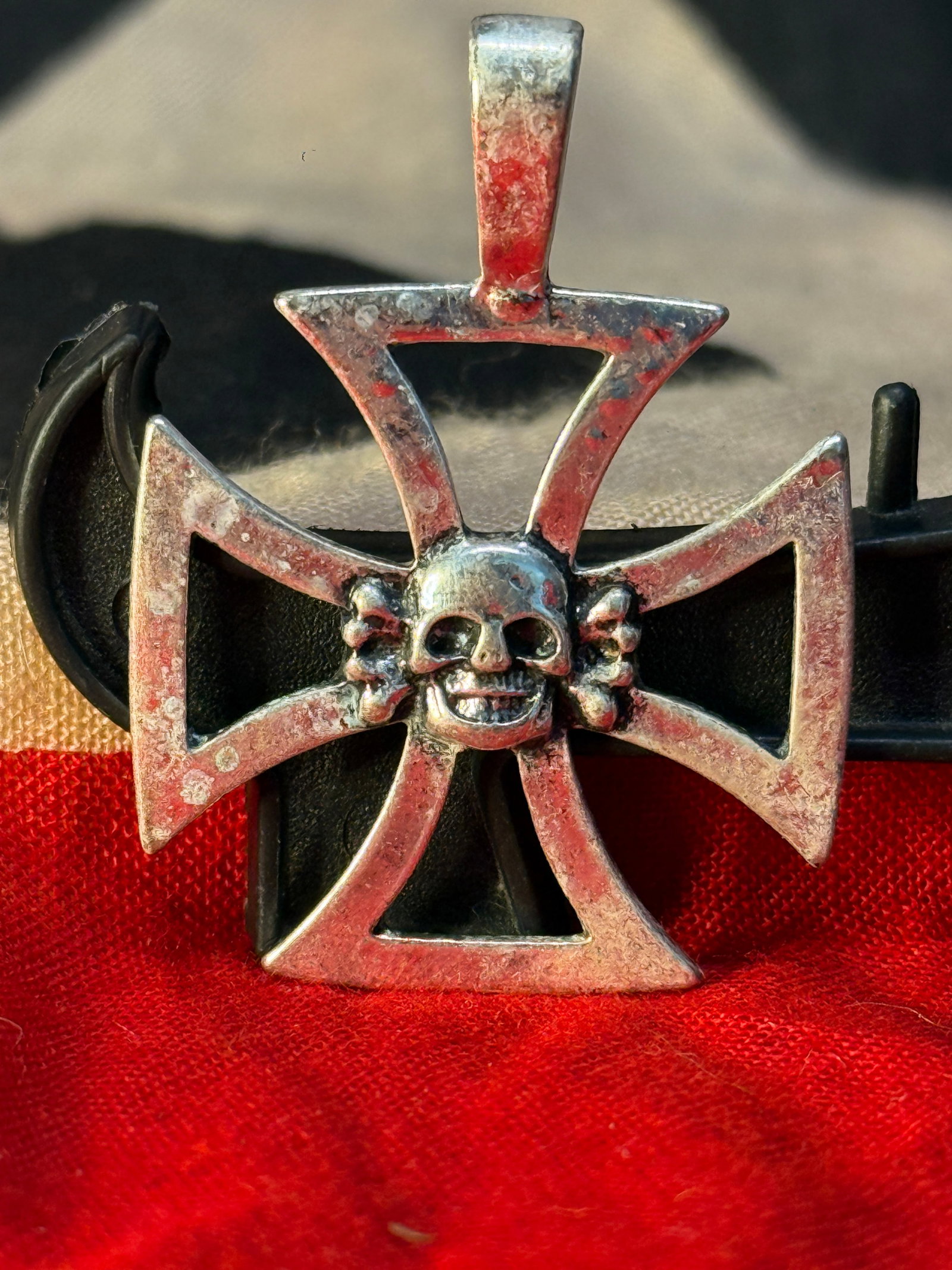 WWII German Skull Cross Silver Pendant: This striking WWII German Skull Iron Cross Pendant is fashioned in the form of an openwork Iron Cross surmounted by a suspension loop, with a prominent skull and crossed bones at its center. The rever