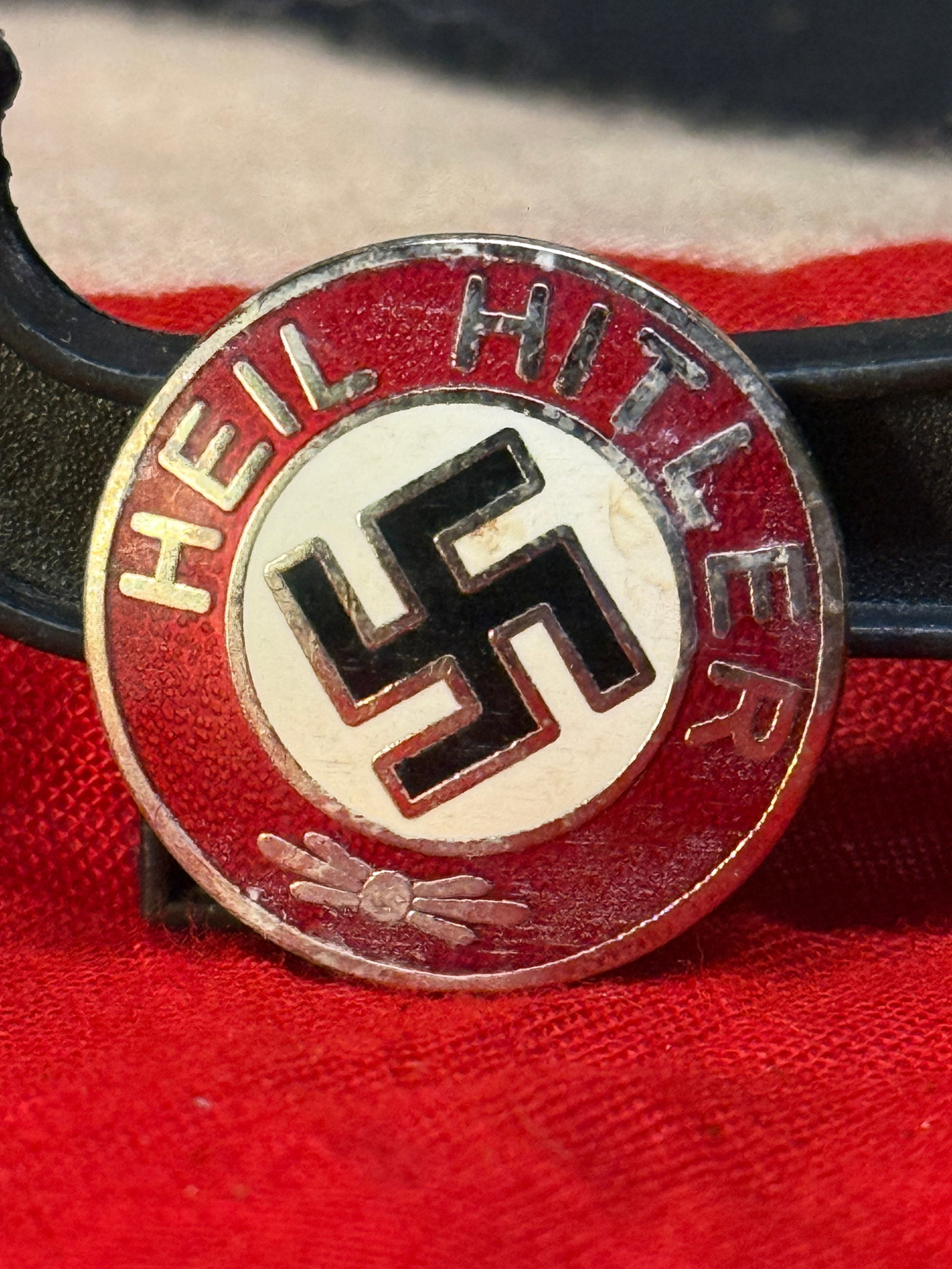 WWII German Hitler Youth Membership Badge By RZM M1/129: This WWII German Hitler Youth (Hitlerjugend) membership badge features the classic red, white, and black enamel design with the inscription "HEIL HITLER" surrounding the central swastika. The reverse 