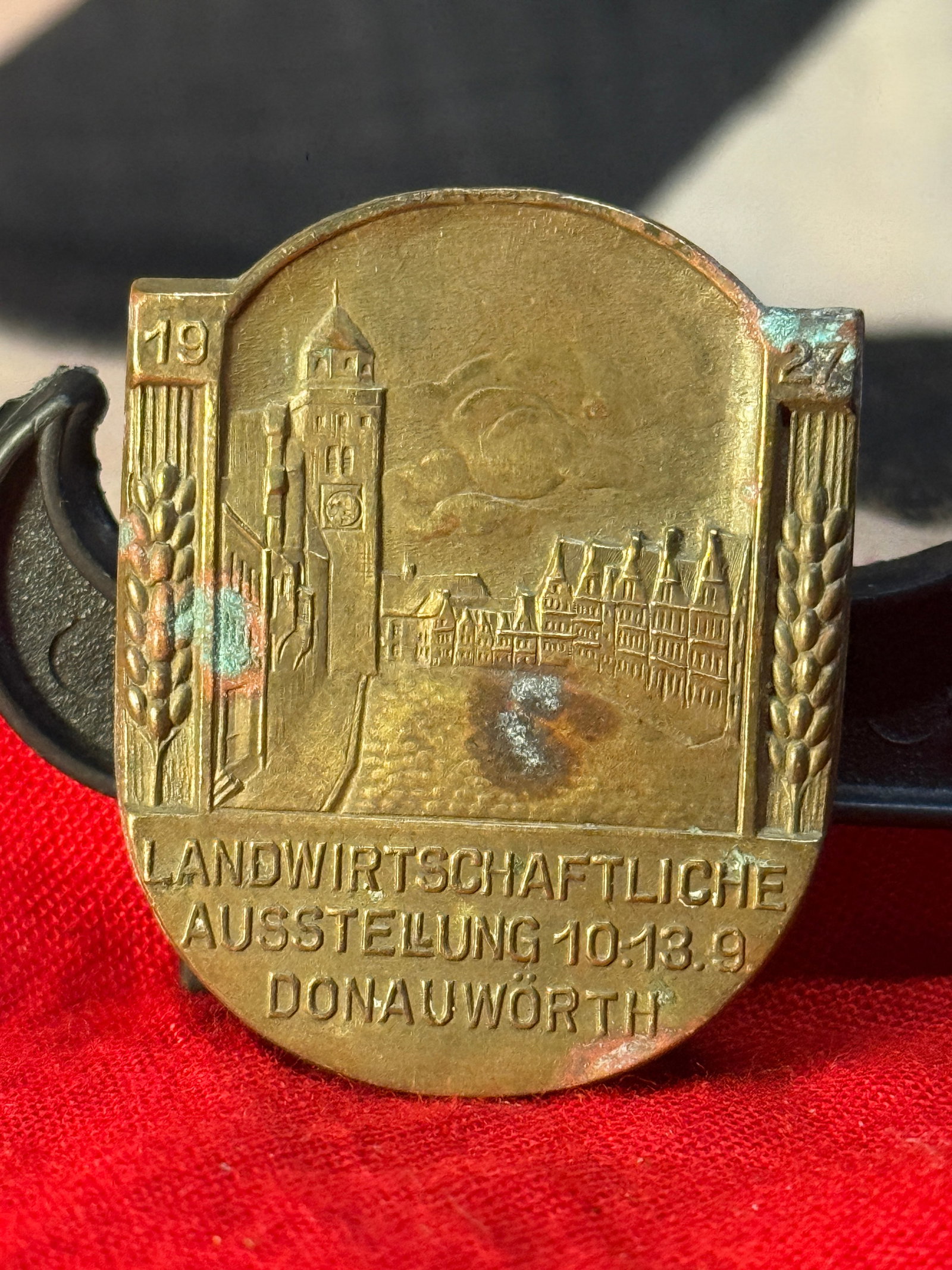 WWII German Agricultural Exhibition Donauwörth Tinnie Badge (1927): This bronze-colored commemorative tinnie was issued for the Landwirtschaftliche Ausstellung (Agricultural Exhibition) held in Donauwörth from 10–13 September 1927. The obverse depicts a detailed ci