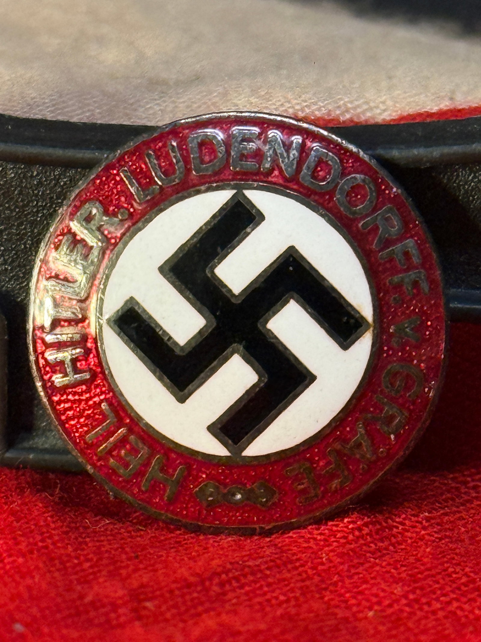WWII German NSDAP Party Membership Badge – RZM M1/73 Marked: This circular enamel NSDAP Party Membership Badge features the black swastika on a white enamel field surrounded by a red enamel border bearing the inscription "National-Sozialistische D.A.P." The rev