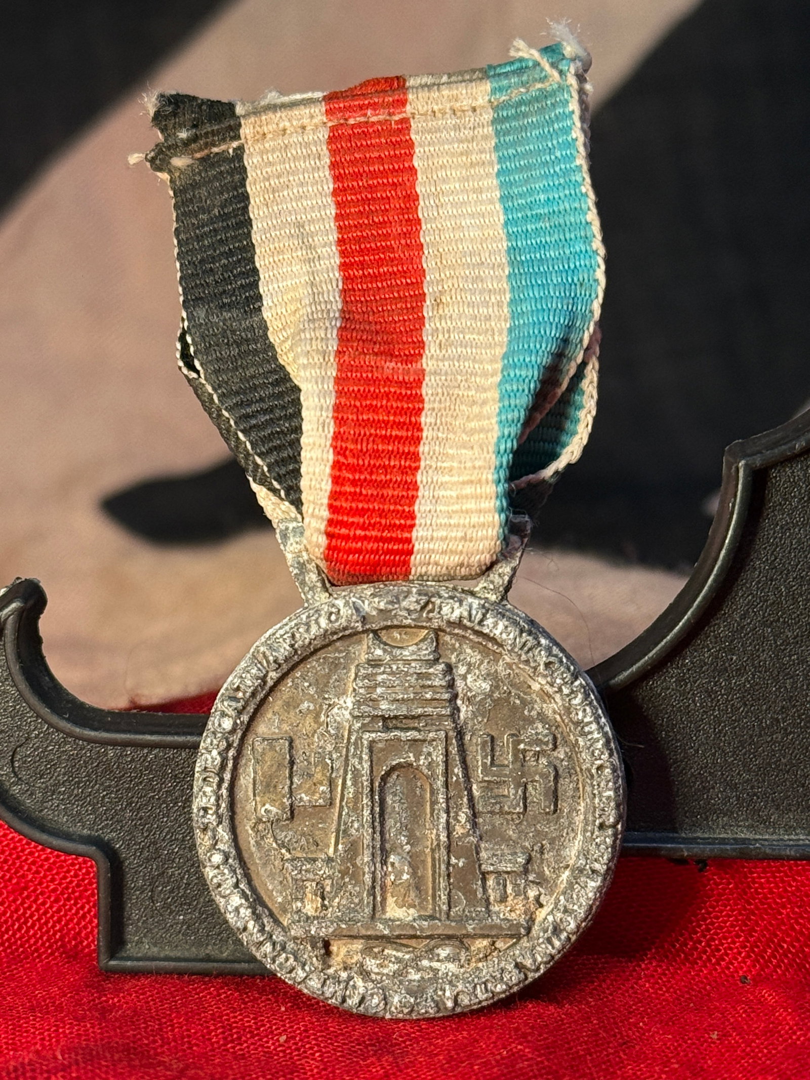 WWII German Italian African Campaign Medal Afrika Korps North Africa Ribbon: WWII German-Italian African Campaign medal featuring raised military imagery and Axis-era symbols, suspended from a striped black, white, red, white, and blue ribbon. The reverse depicts two armored m