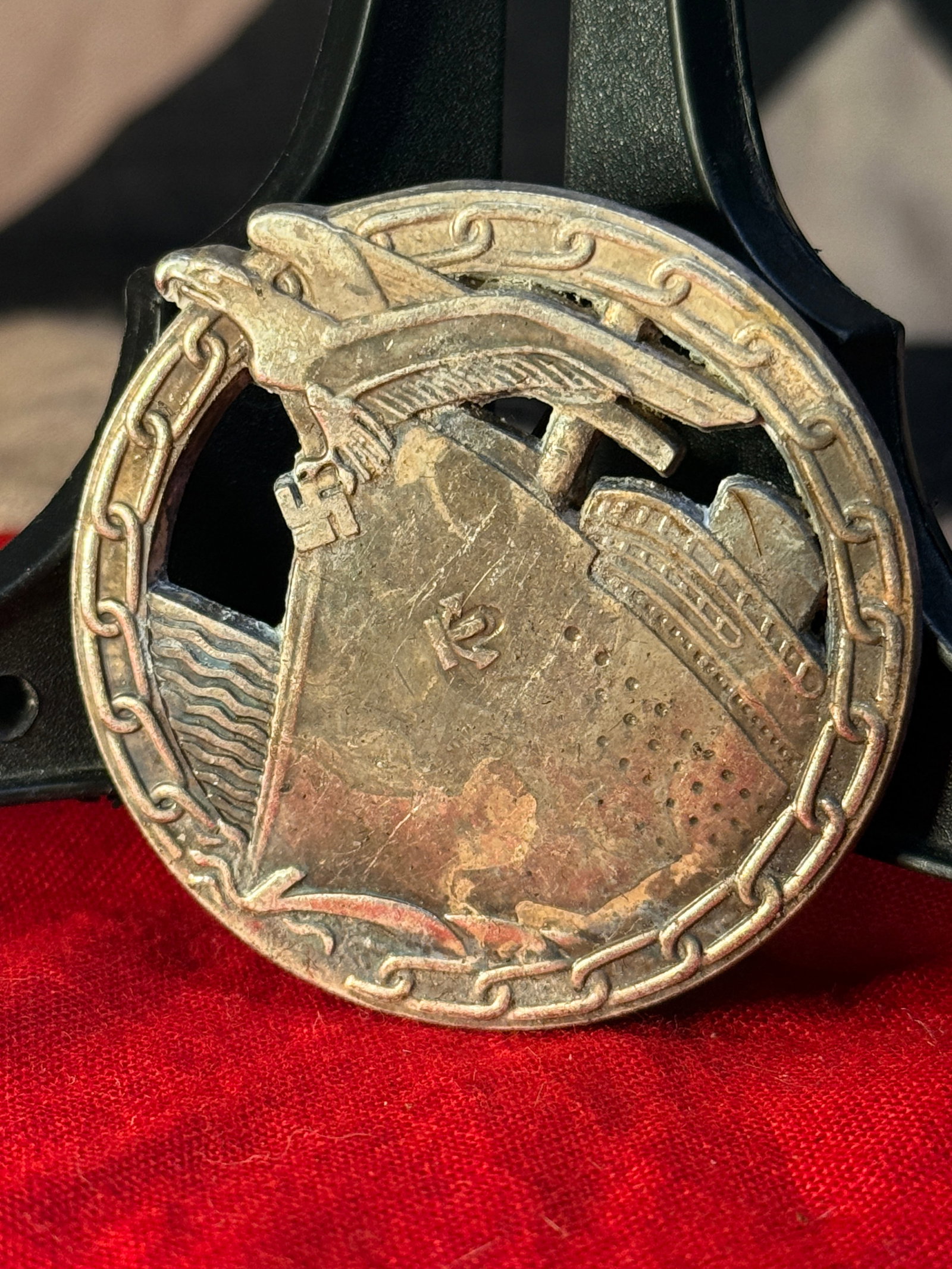 WWII German Kriegsmarine Blockade Runner Badge Fec. Otto Placzek Berlin: This Kriegsmarine Blockade Runner Badge depicts a merchant vessel forcing its way through a heavy chain beneath the national eagle clutching a swastika. Instituted in 1941, the decoration recognized o