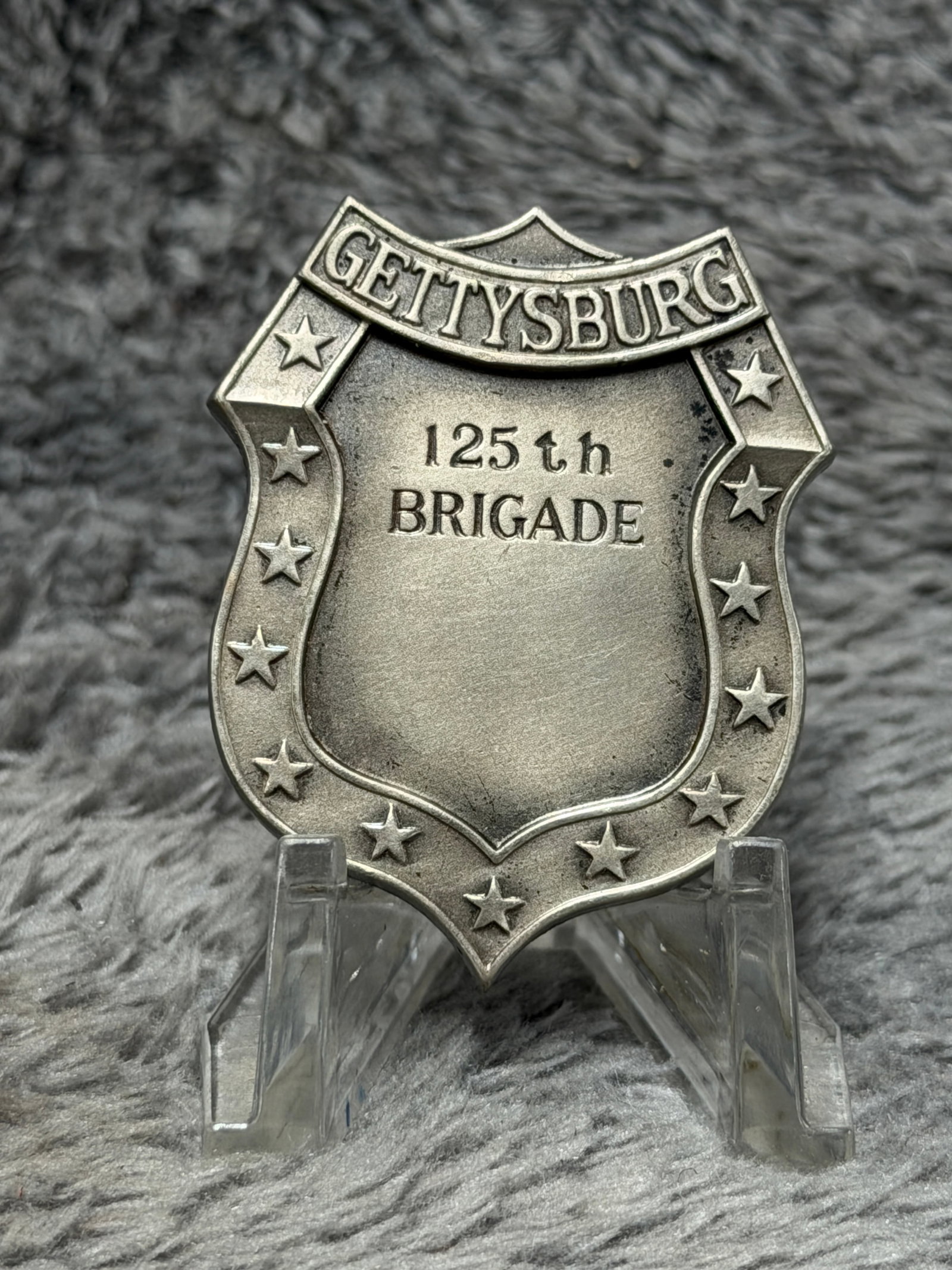 Civil War Gettysburg 125th Brigade Shield-Shaped Veteran Badge: This striking shield-shaped military badge is prominently marked “GETTYSBURG” across the raised upper banner with “125th BRIGADE” stamped into the central field. The perimeter is decor