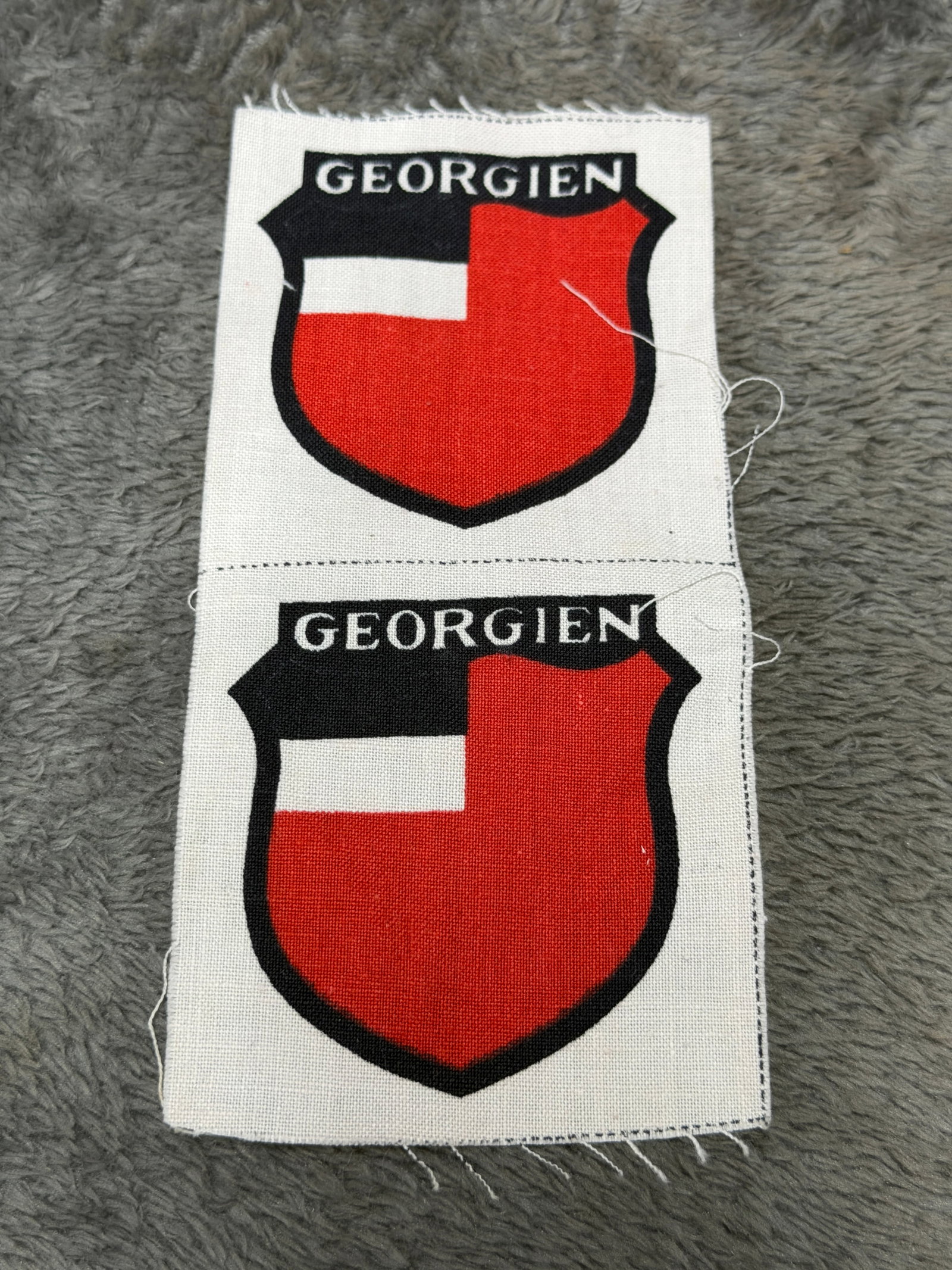 WWII German Georgian Volunteer “Georgien?? Wehrmacht Foreign Legion Sleeve Shields – Uncut Pair: A visually striking pair of WWII German Georgian volunteer sleeve shields bearing the designation “GEORGIEN,” associated with Georgian personnel serving in German-organized Eastern volunteer f